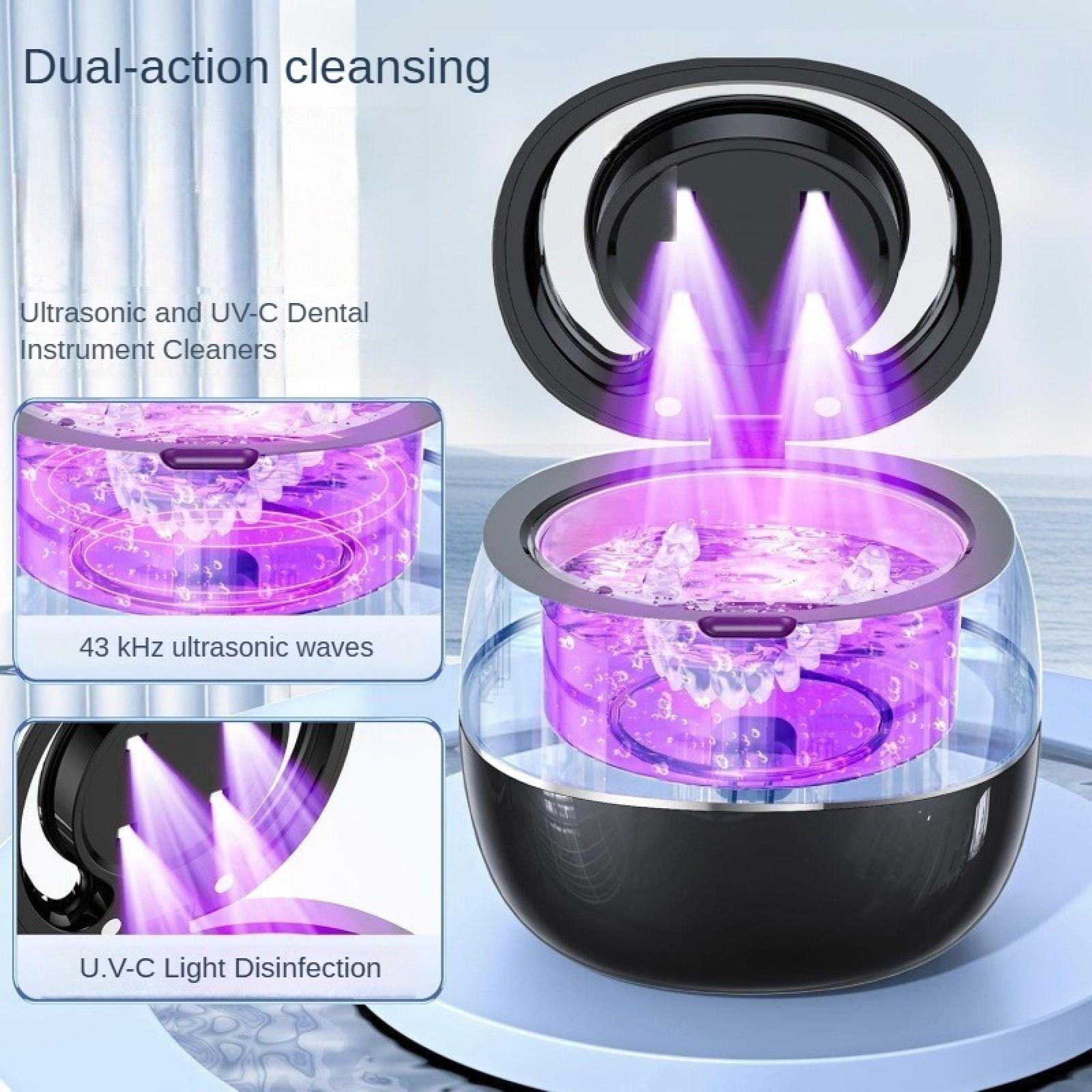 Ein Dentalinstrumentenreiniger mit UV-C-Licht und Ultraschallwellen. Das Gerät ist schwarz mit einem transparenten Behälter.