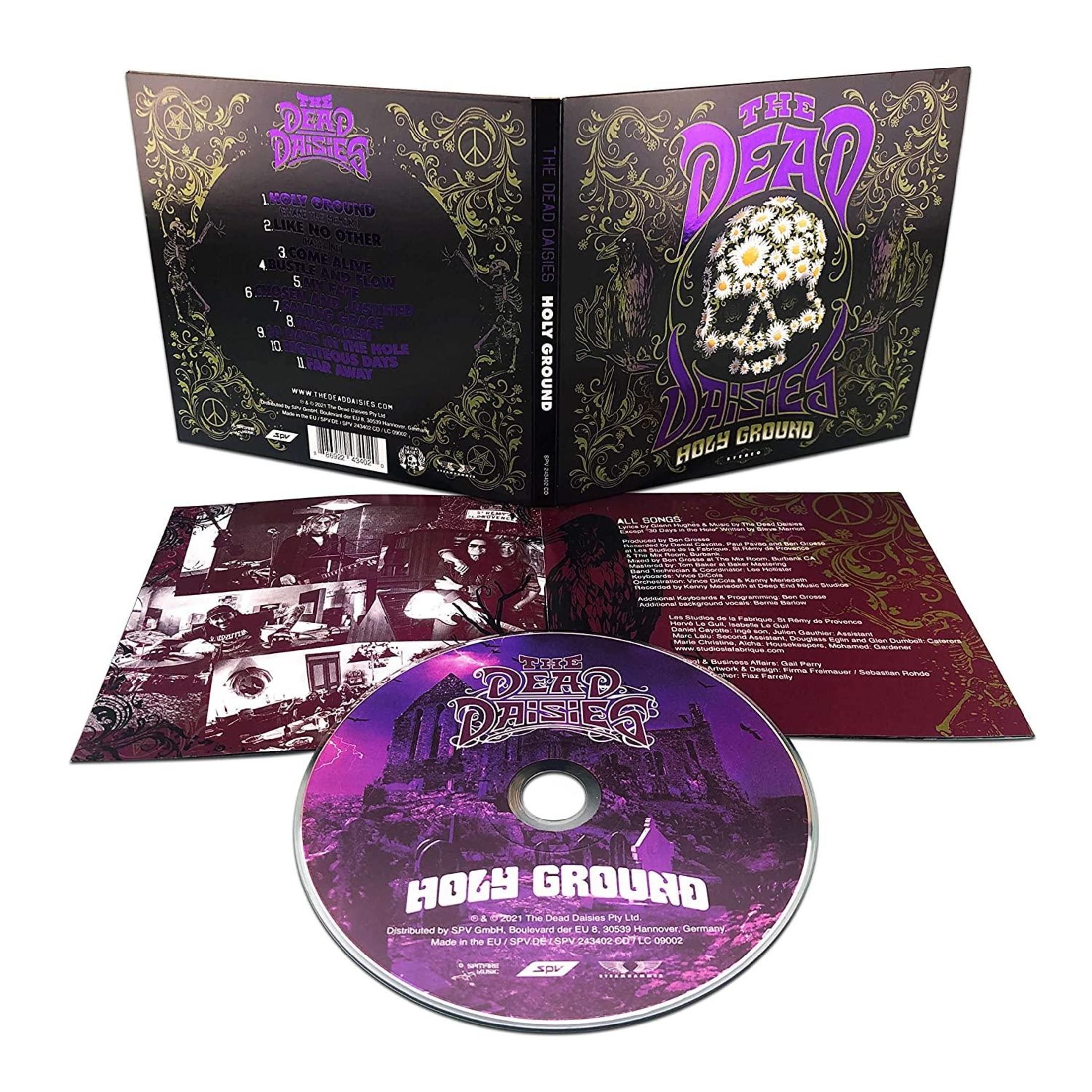 Albumhoes voor The Dead Daisies: Holy Ground. Toont schedel met madeliefjes, een kraai en de cd in de hoes.