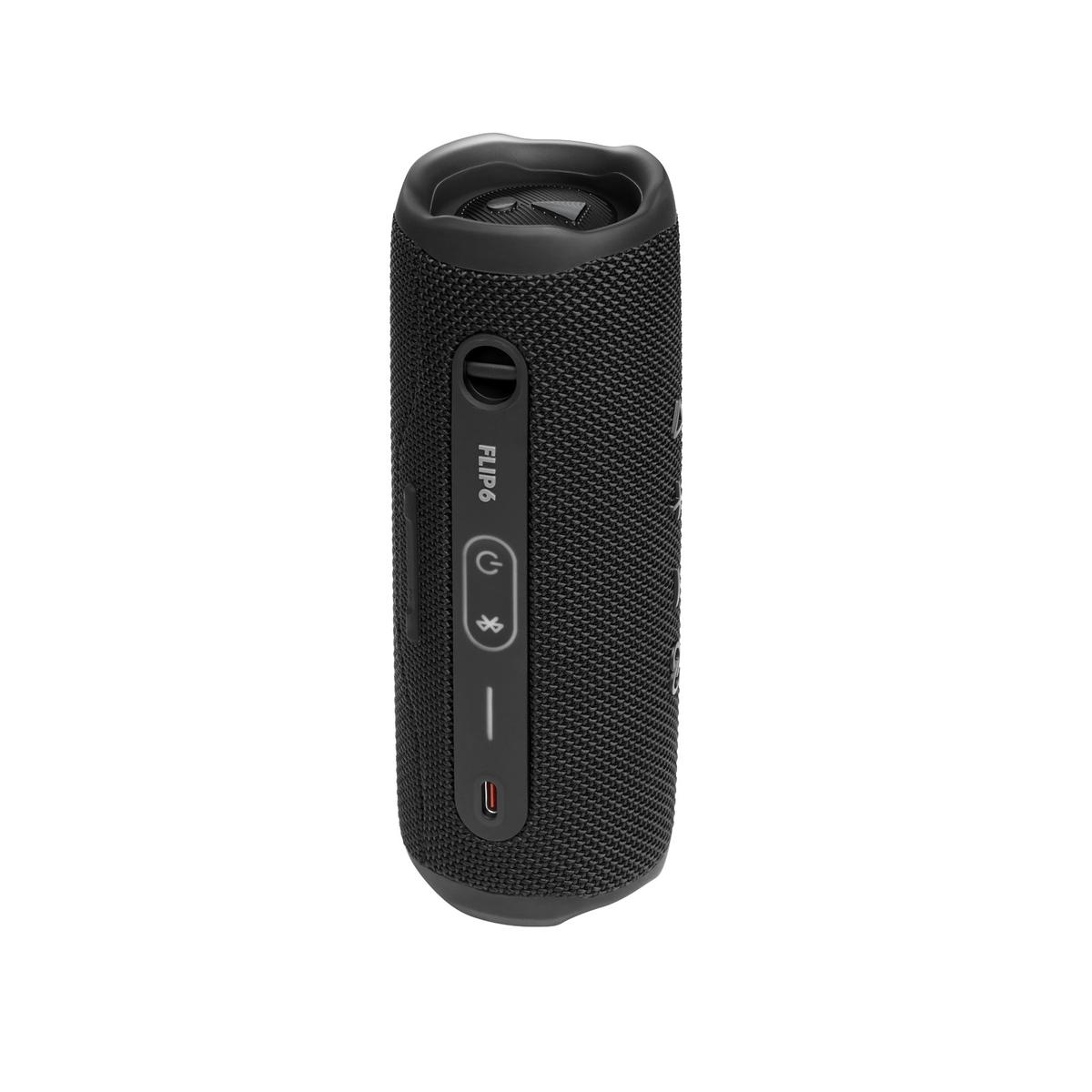 Un altavoz negro JBL Flip 6 está de pie. Tiene botones de control, un puerto de carga y el texto "FLIP 6" en el lado.