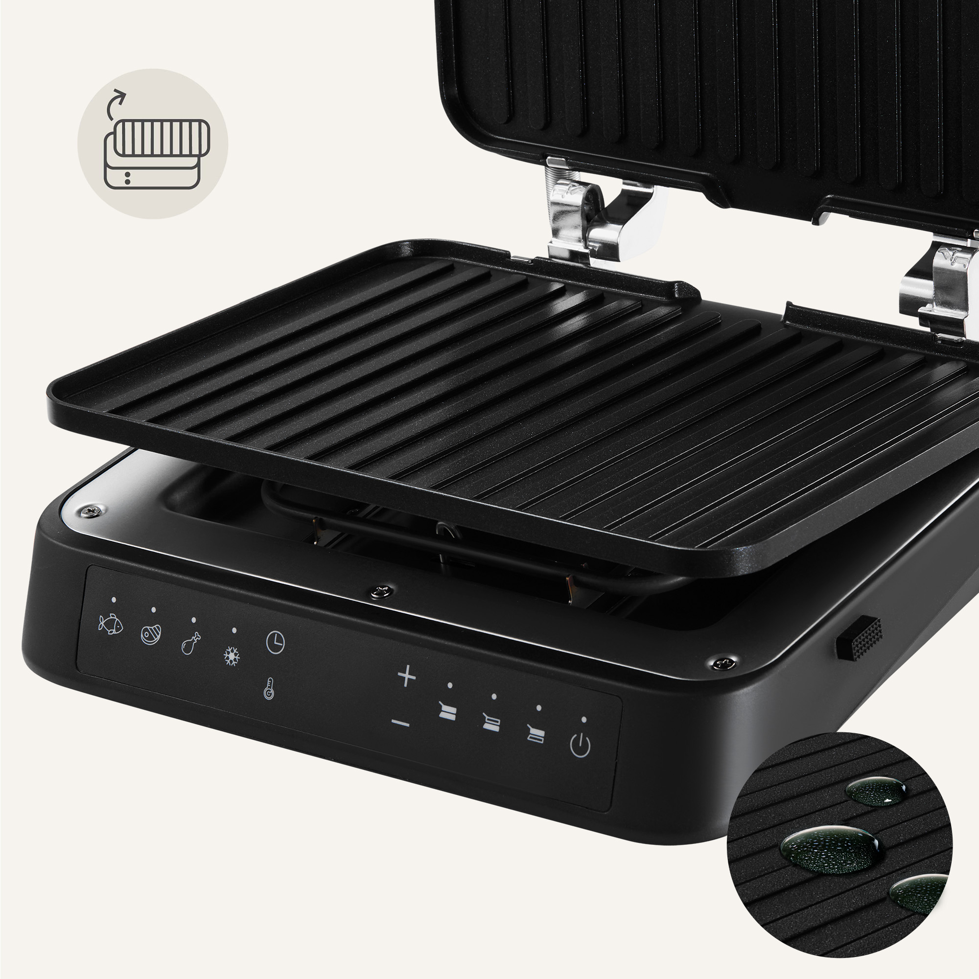 Black grill with open lid. It has a control panel with icons. The surface shows water drops.