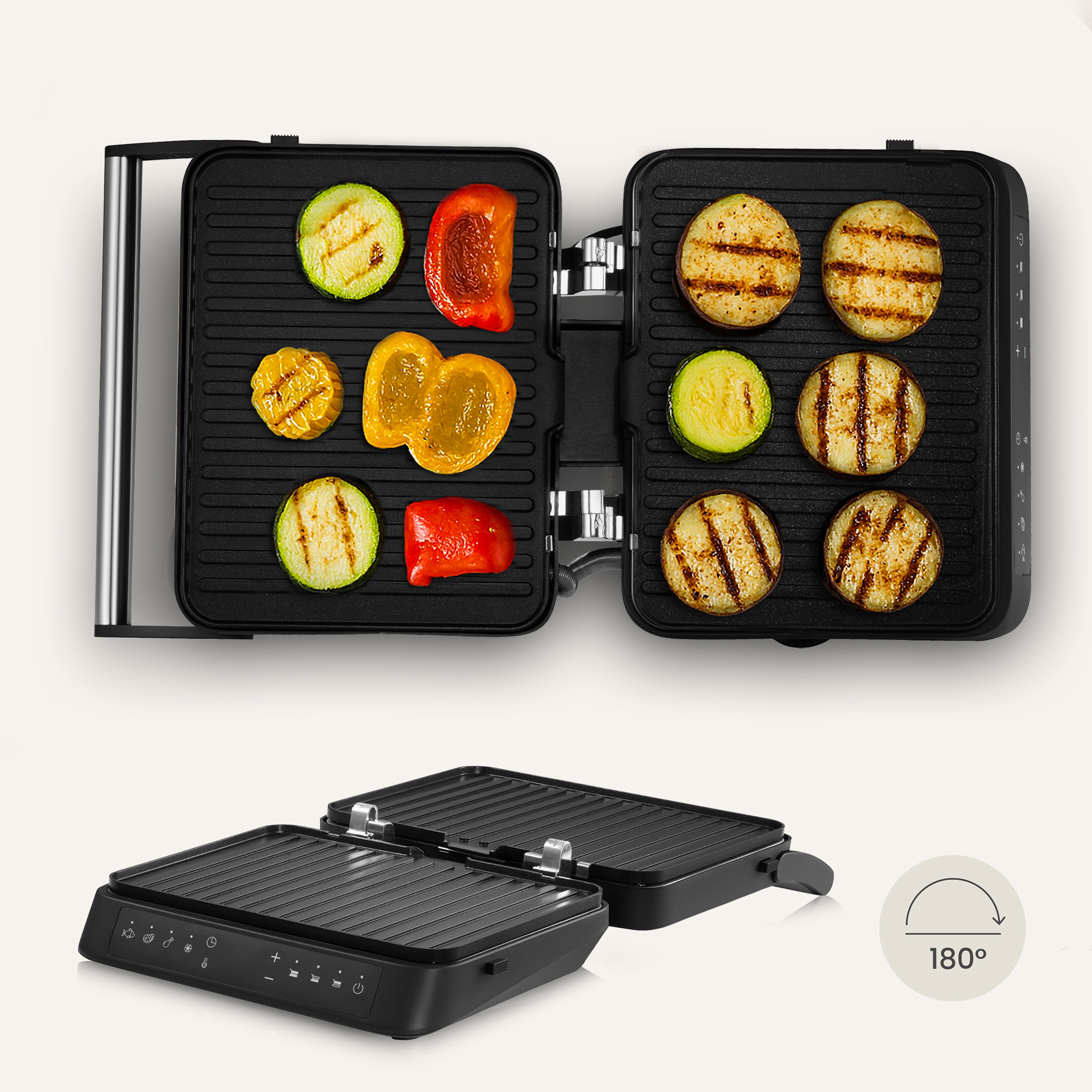 An open black grill with grilled vegetables. Sliced zucchini, yellow and red peppers, and eggplant are visible.