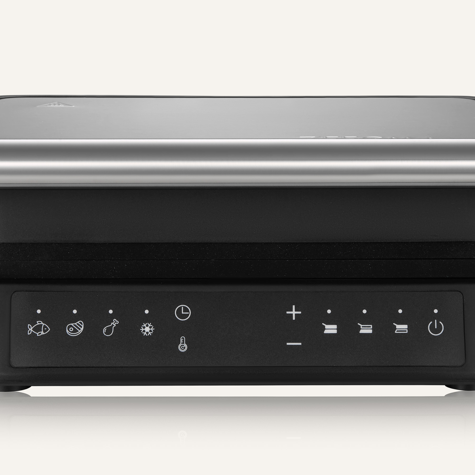 Close-up of a black grill with control panel featuring food icons, temperature controls, and a power button. Silver handle at top.