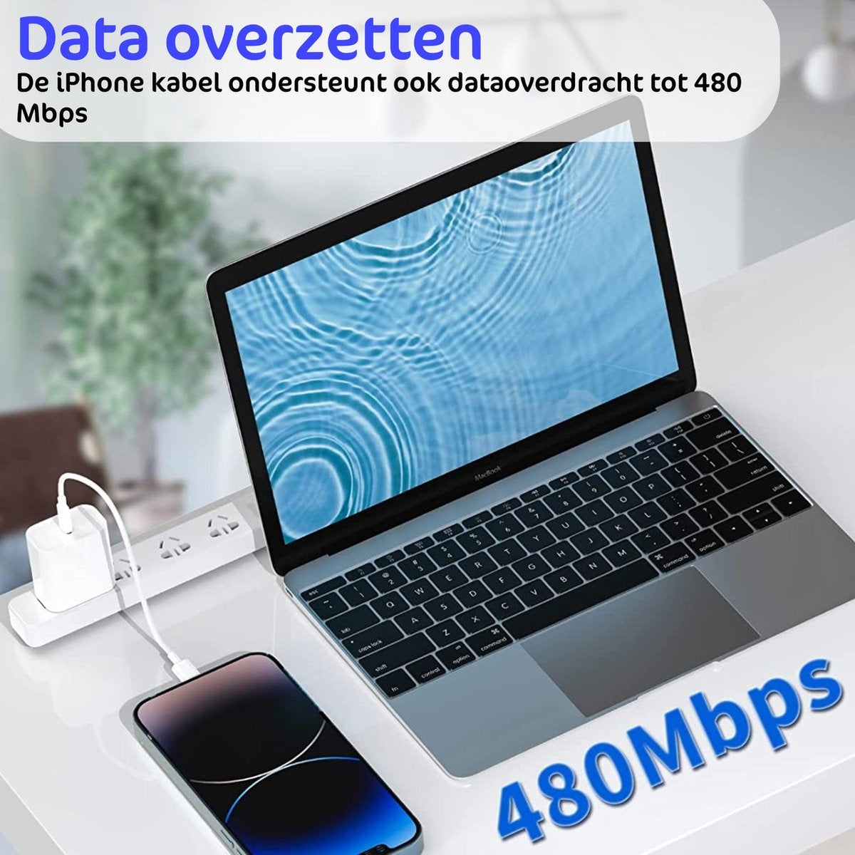 A laptop, phone, and charger are on a white surface. The phone is connected to the laptop, and the charger is plugged in.