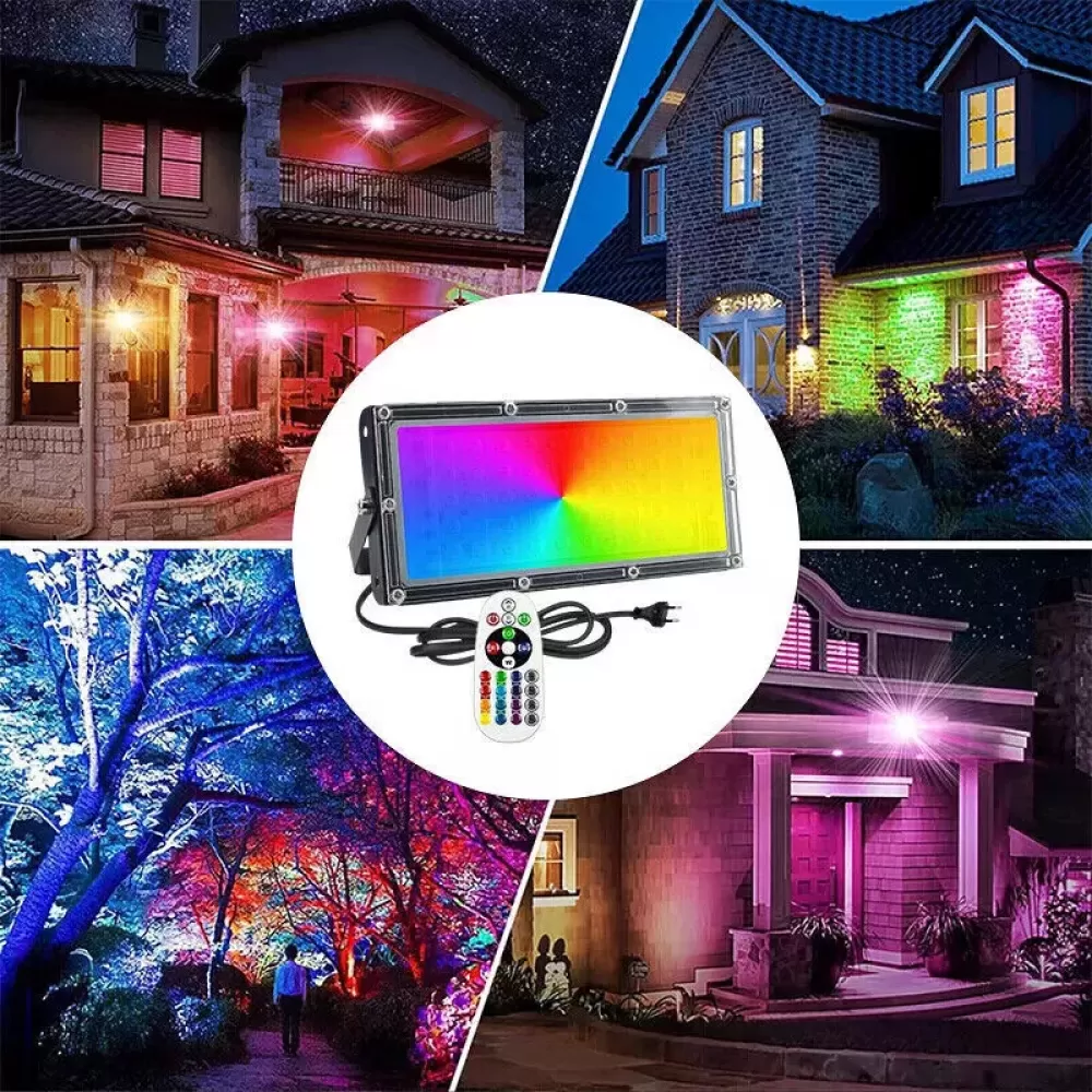 Ein mehrfarbiger LED-Flutlichtstrahler mit Fernbedienung. Er beleuchtet Häuser und einen Garten in verschiedenen Farben.