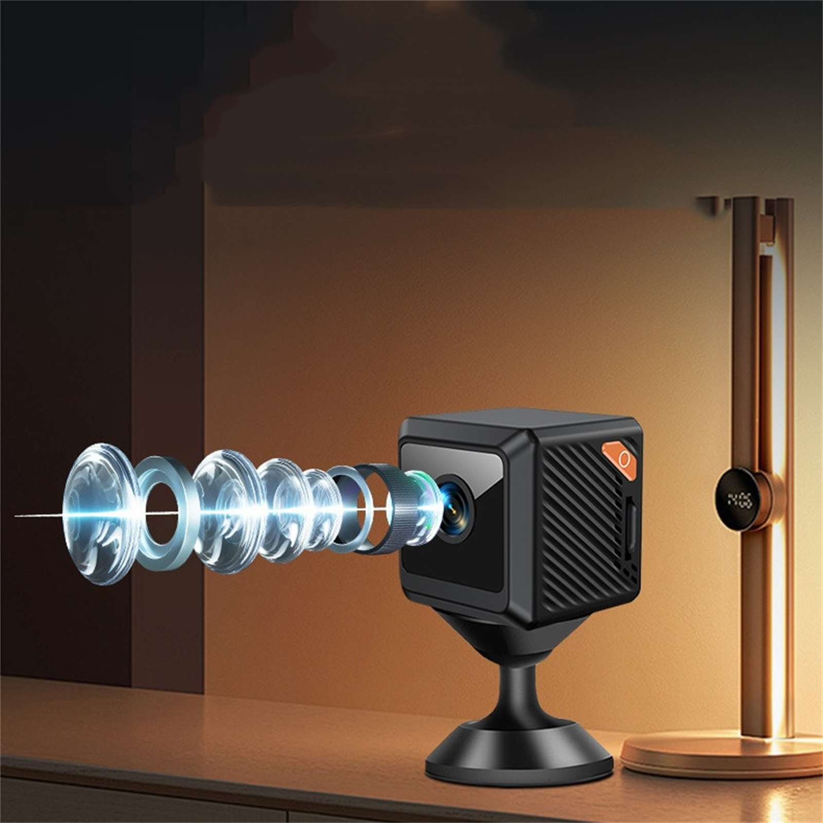 Eine schwarze Würfelkamera mit abgetrennten Objektiven auf einem Ständer. Rechts ist eine Lampe. Der Hintergrund ist braun und schwarz.