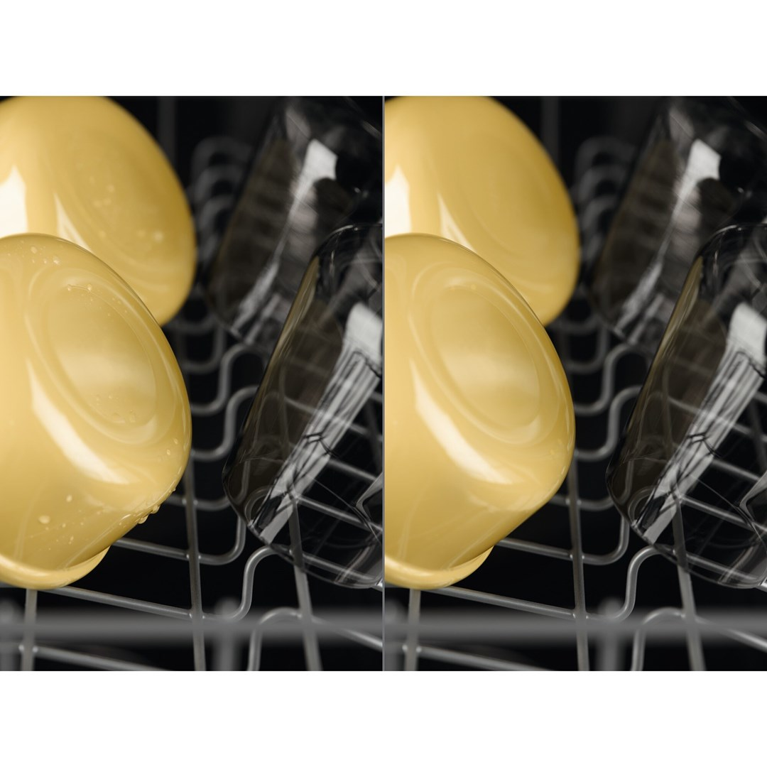 Zbliżenie zmywarki z żółtymi miskami i czarnymi szklankami. Miski są na pierwszym planie, szklanki za nimi.