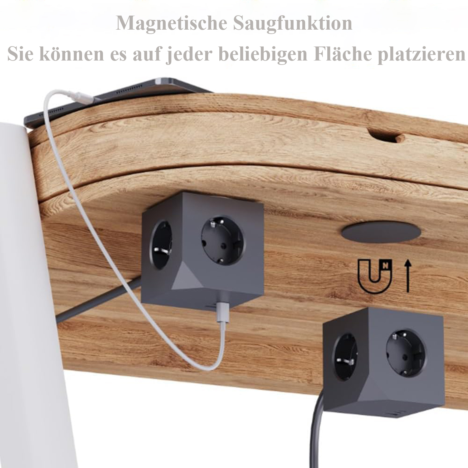 Holzschreibtisch mit Tablet, zwei grauen Stromwürfeln und einem weißen Kabel, das in das Tablet eingesteckt ist.