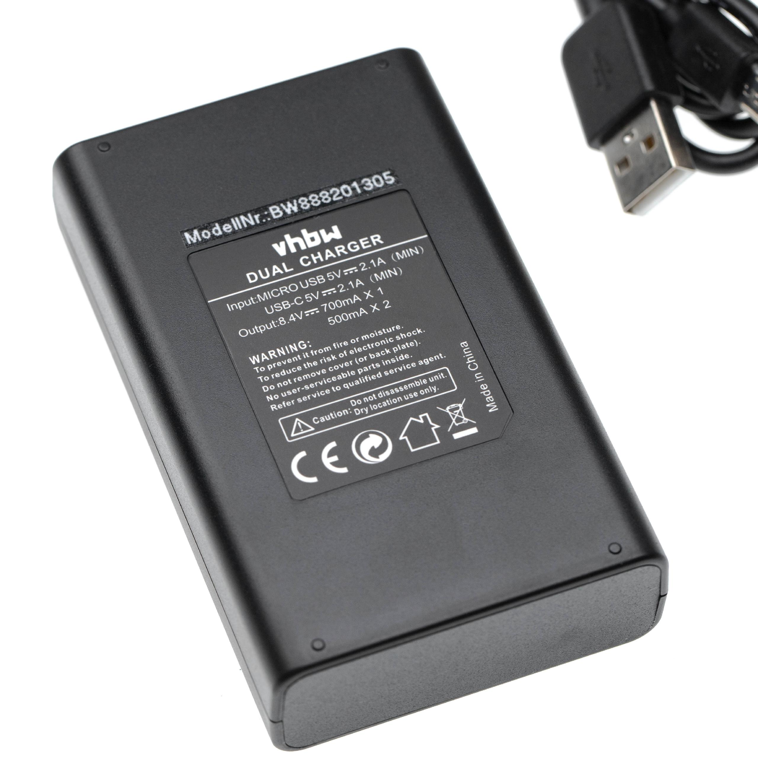 Schwarzes vhbw-Doppelladegerät mit USB-Kabel. Das Ladegerät hat Textetiketten mit technischen Daten und Warnhinweisen.