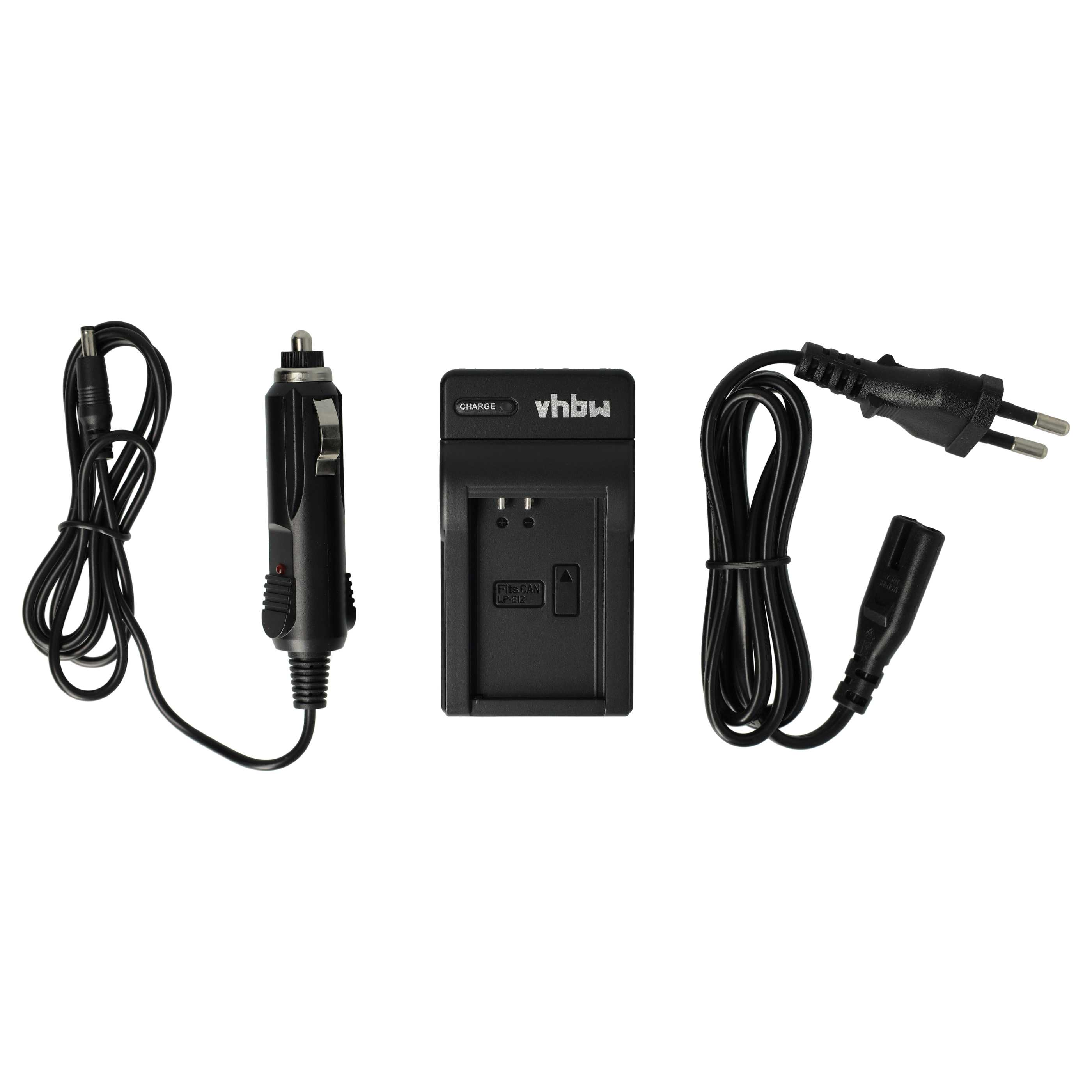 Schwarzes Kamer Ladegerät, ein Auto Adapter und ein Netzkabel auf weißem Untergrund. Das Ladegerät hat 'vhbw'.