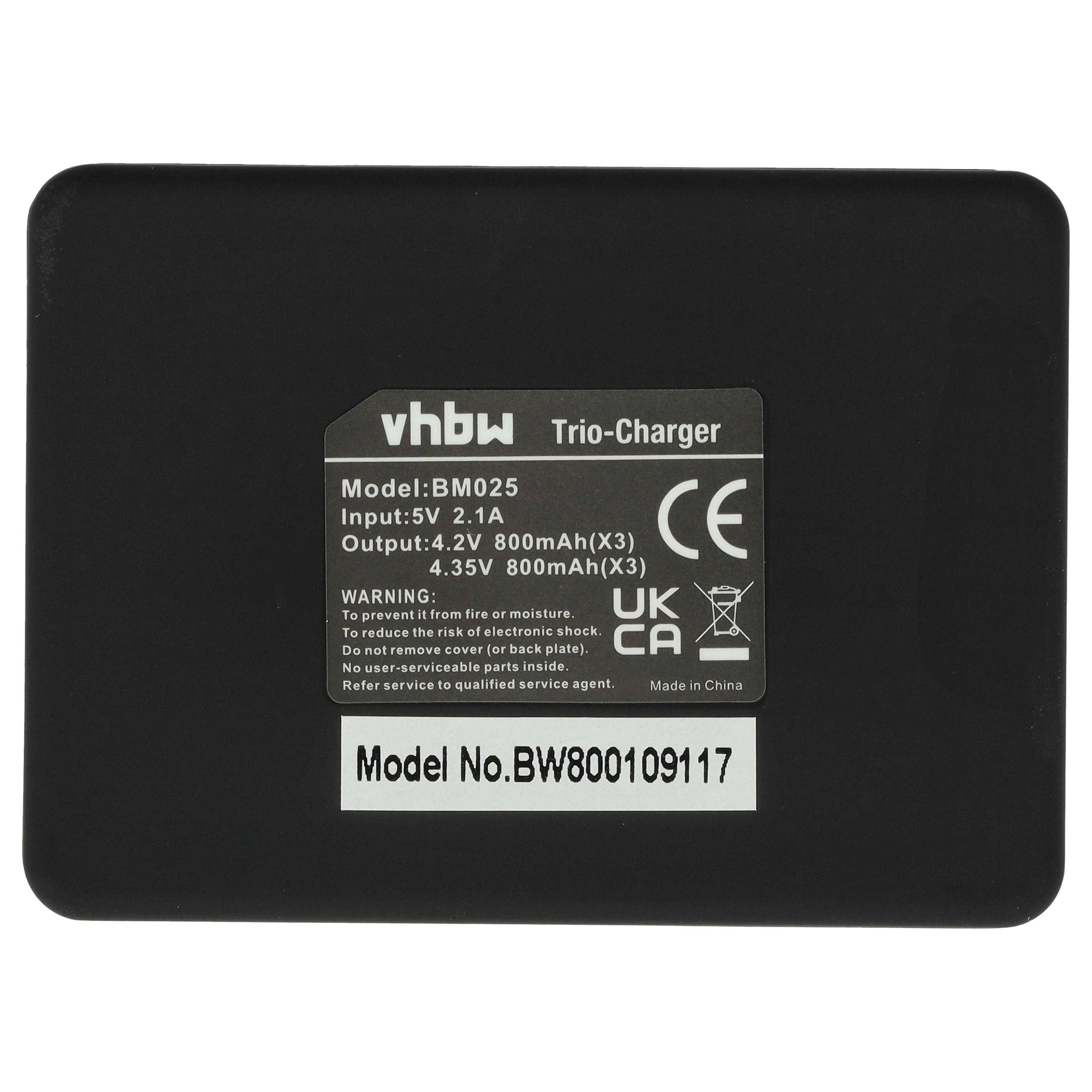 Schwarzes Ladegerät mit weißem Text, einschließlich Modell, Eingang, Ausgang und Warnhinweisen. Das Ladegerät ist mit vhbw Trio-Charger beschriftet.