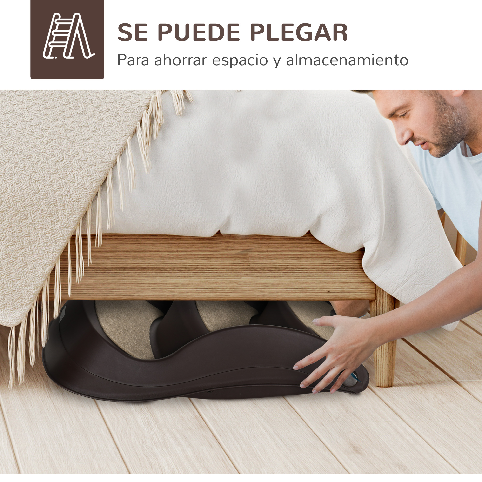 Un hombre saca un contenedor de almacenamiento marrón de debajo de una cama de madera. Una manta crema cuelga de la cama.
