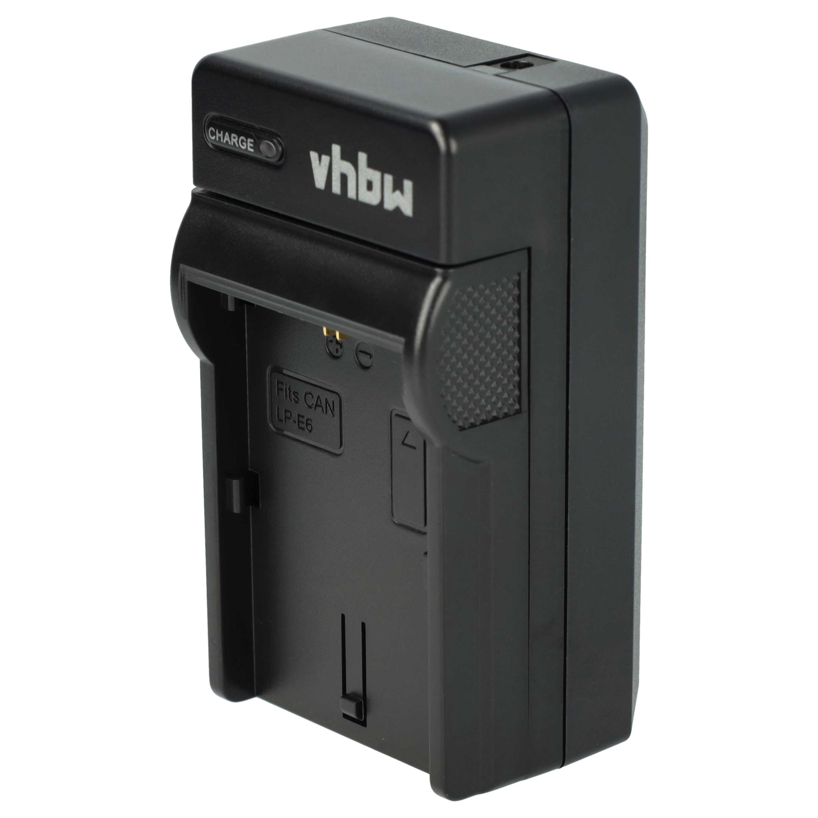 Schwarzes vhbw-Batterieladegerät. Hat eine Ladeanzeige und einen Steckplatz für eine Batterie. Mit dem Text 'Fits CAN LP-E6'.
