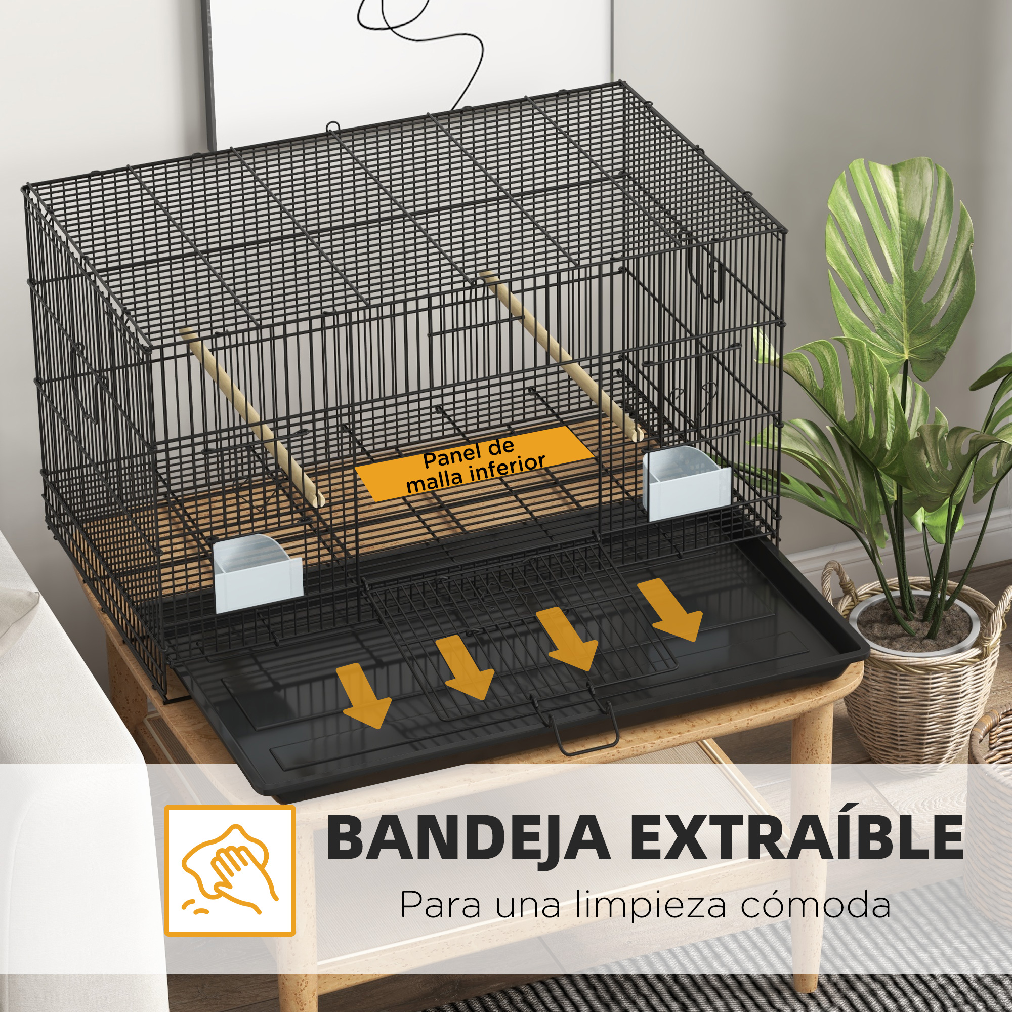 Una jaula negra para pájaros con bandeja extraíble sobre una mesa de madera. Una planta en maceta a la derecha. Texto: 'Bandeja extraíble para fácil limpieza'.