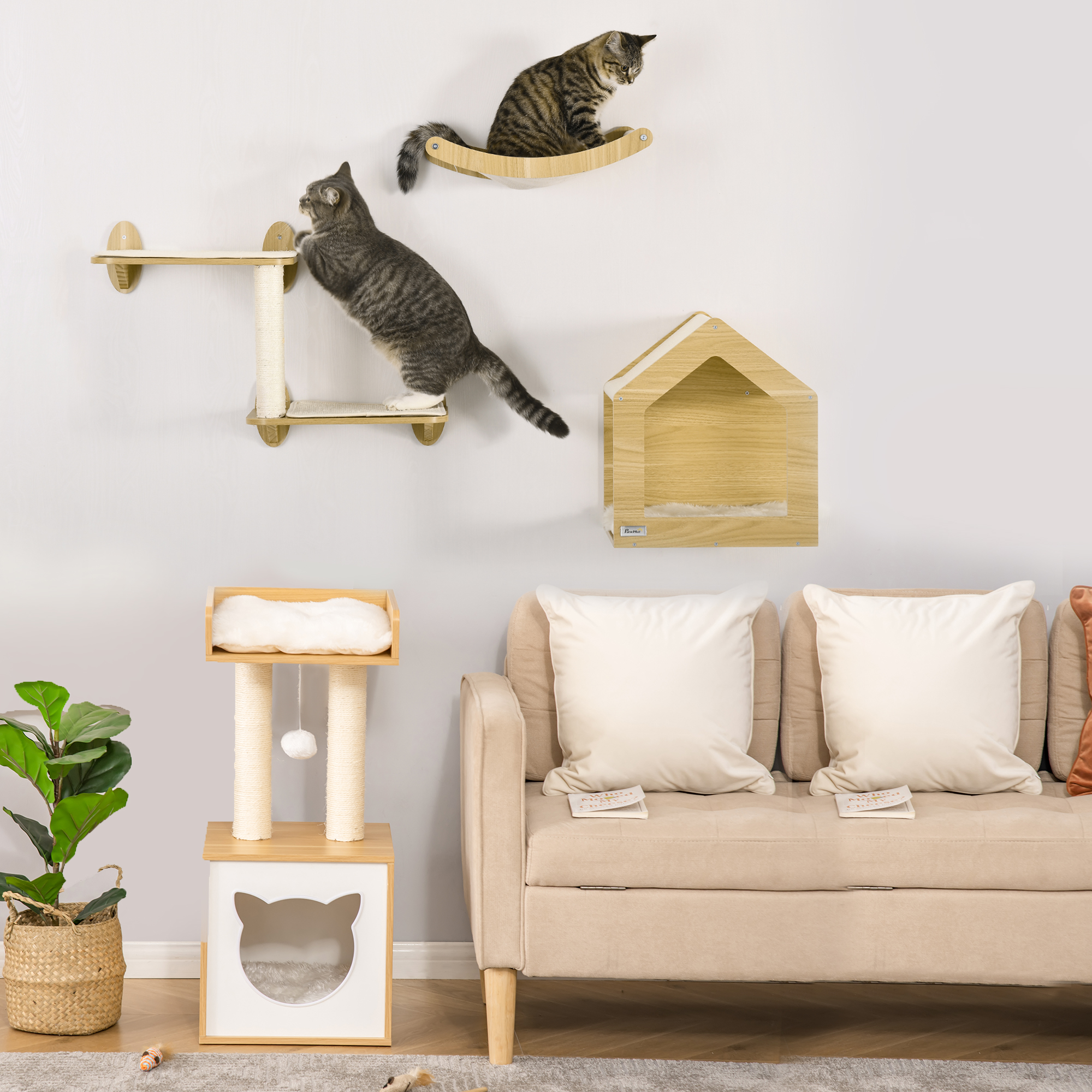 Dos gatos en estantes para gatos montados en la pared. Un árbol para gatos y un sofá con almohadas también están en la escena. Una planta está a la izquierda.