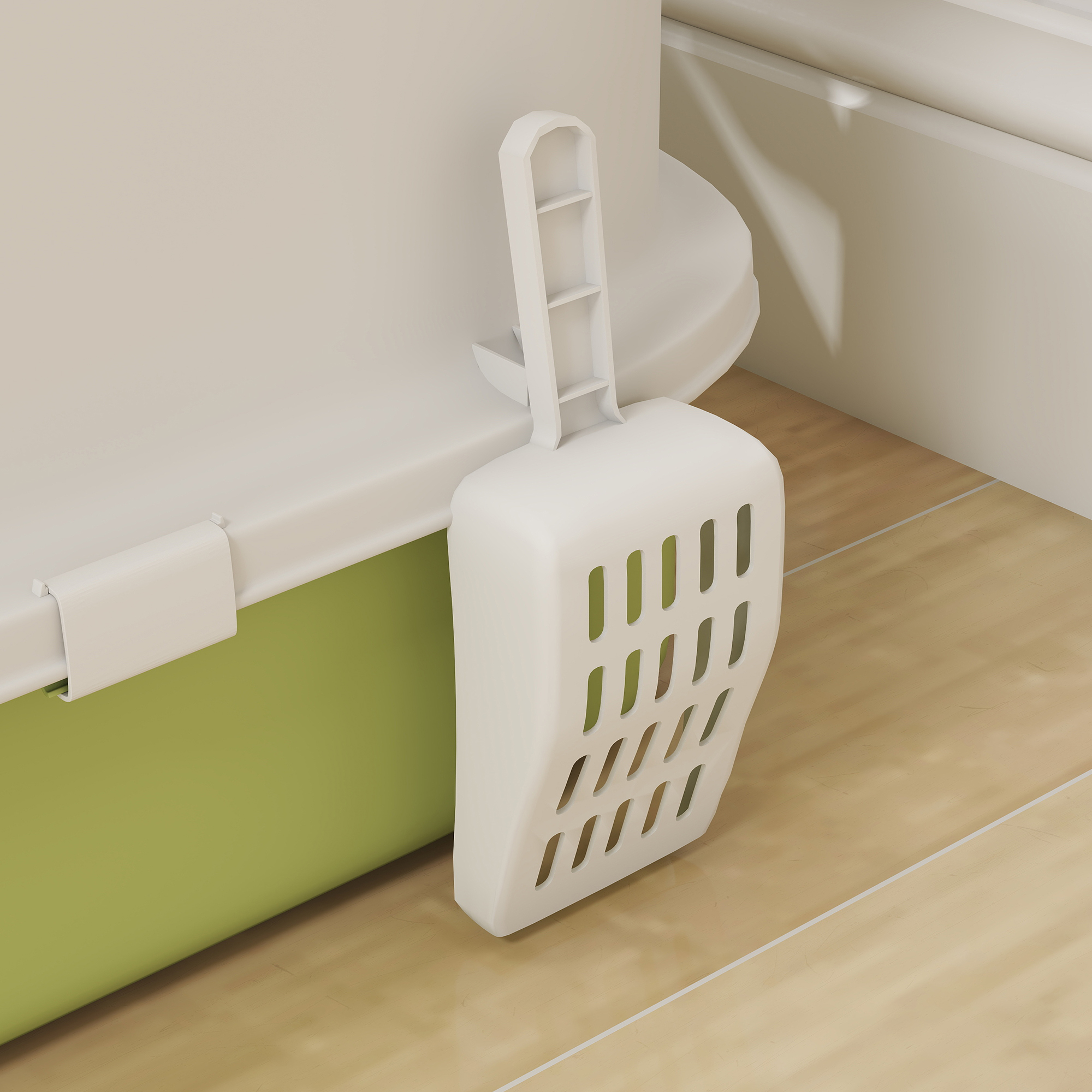 Una pala blanca para arena de gato cuelga de una caja cerrada verde y blanca para arena de gato en un piso de madera.