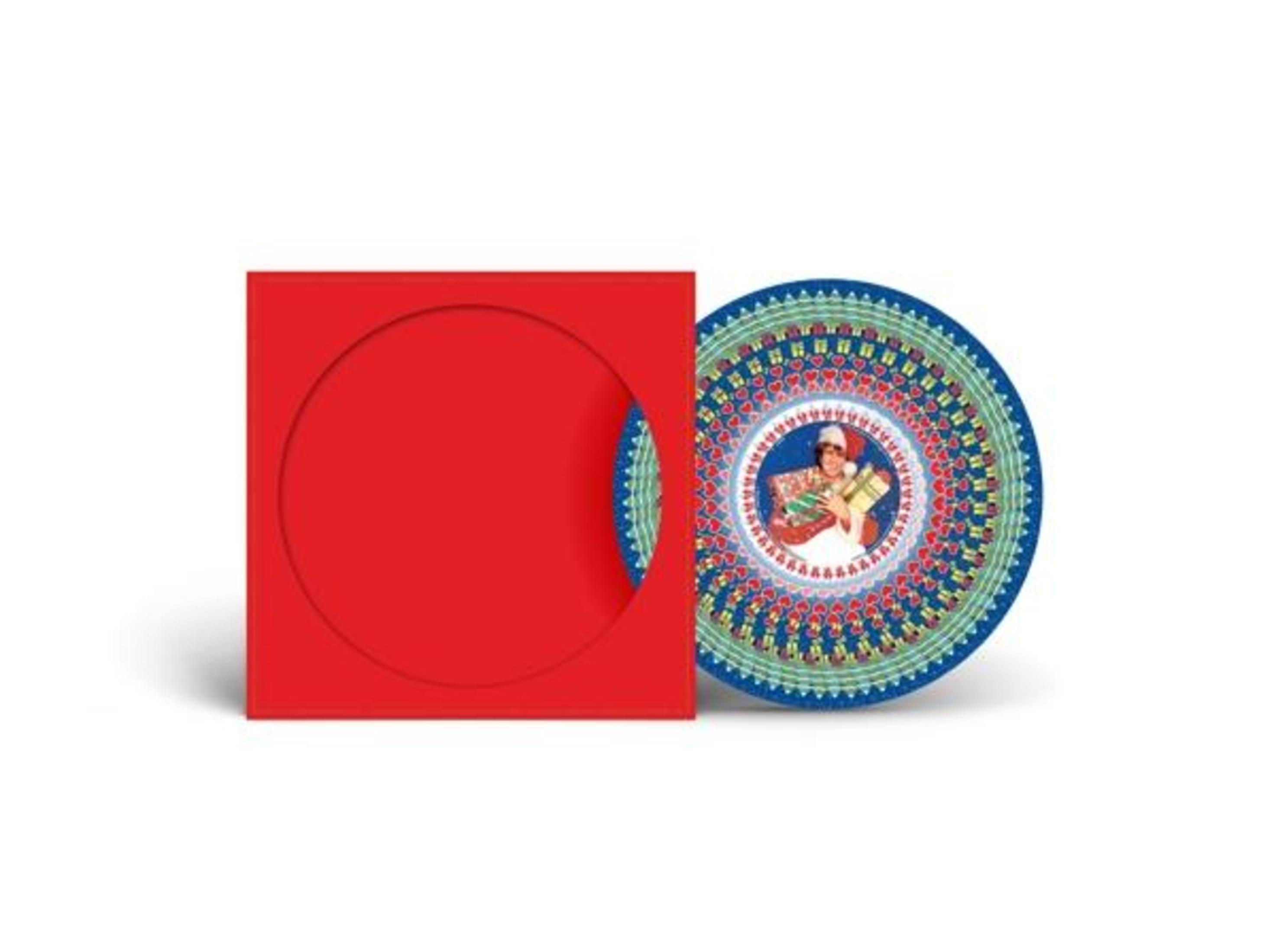 CD in roter Hülle. Die CD zeigt eine Person mit Geschenken, umgeben von einem blau-grünen Muster.