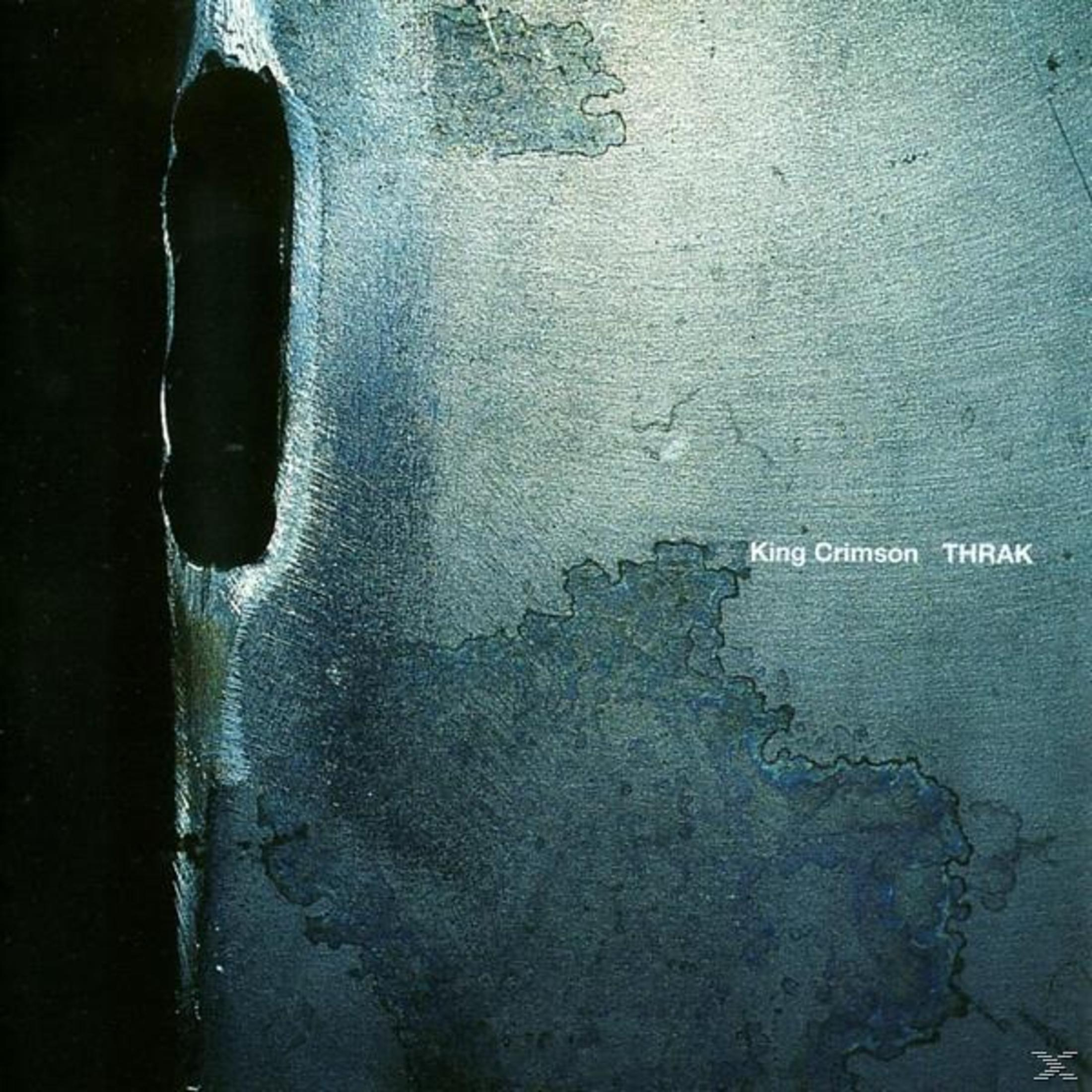 Album cover for King Crimson's 'Thrak'. A textured, metallic surface with a dark void on left. 'King Crimson Thrak' is visible.
