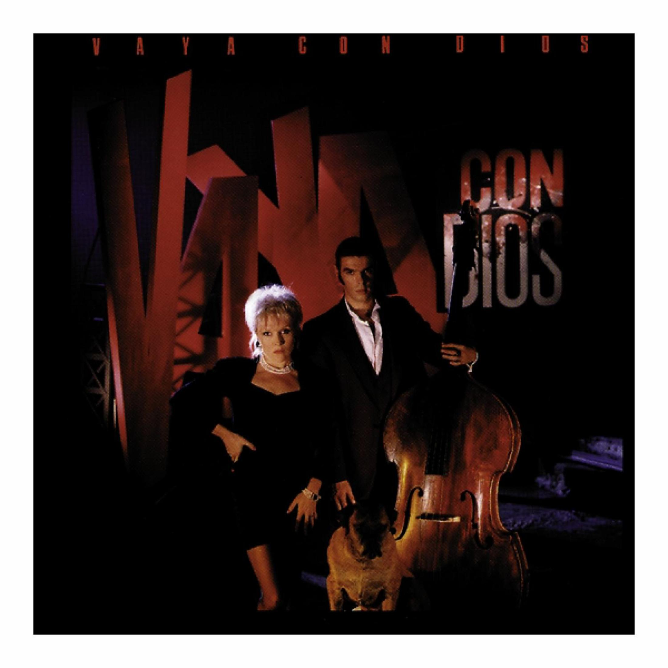 Albumcover: Eine Frau und ein Mann stehen mit einem Hund. Rechts ist ein Cello. Die Worte "Vaya Con Dios" stehen oben.