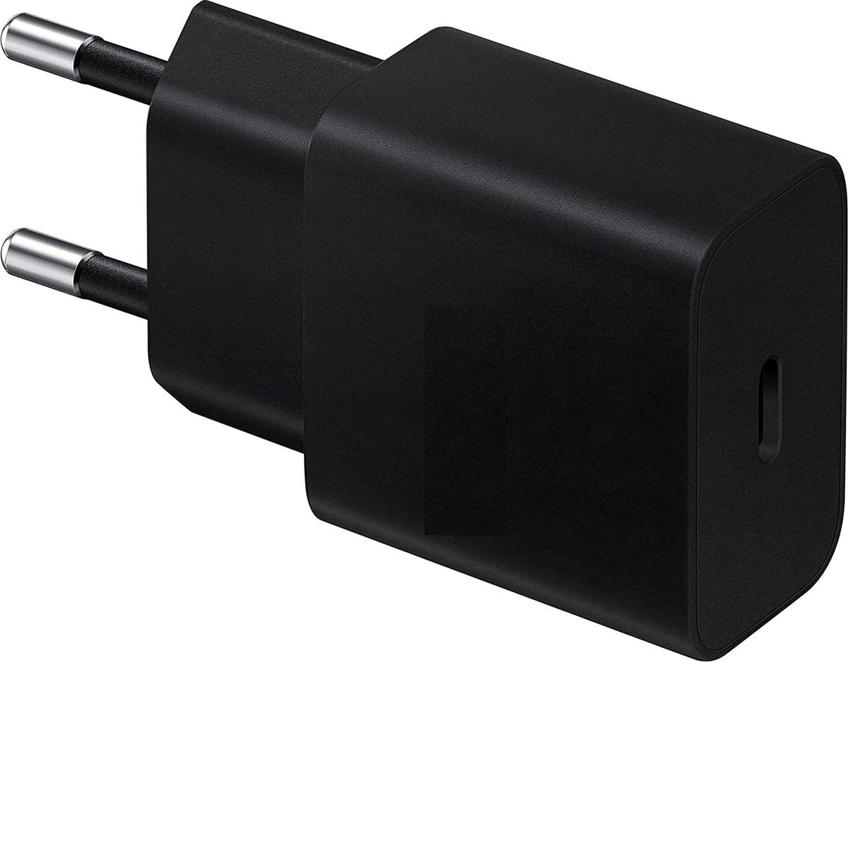A black phone charger adapter with two silver prongs. It is plugged into a wall outlet.