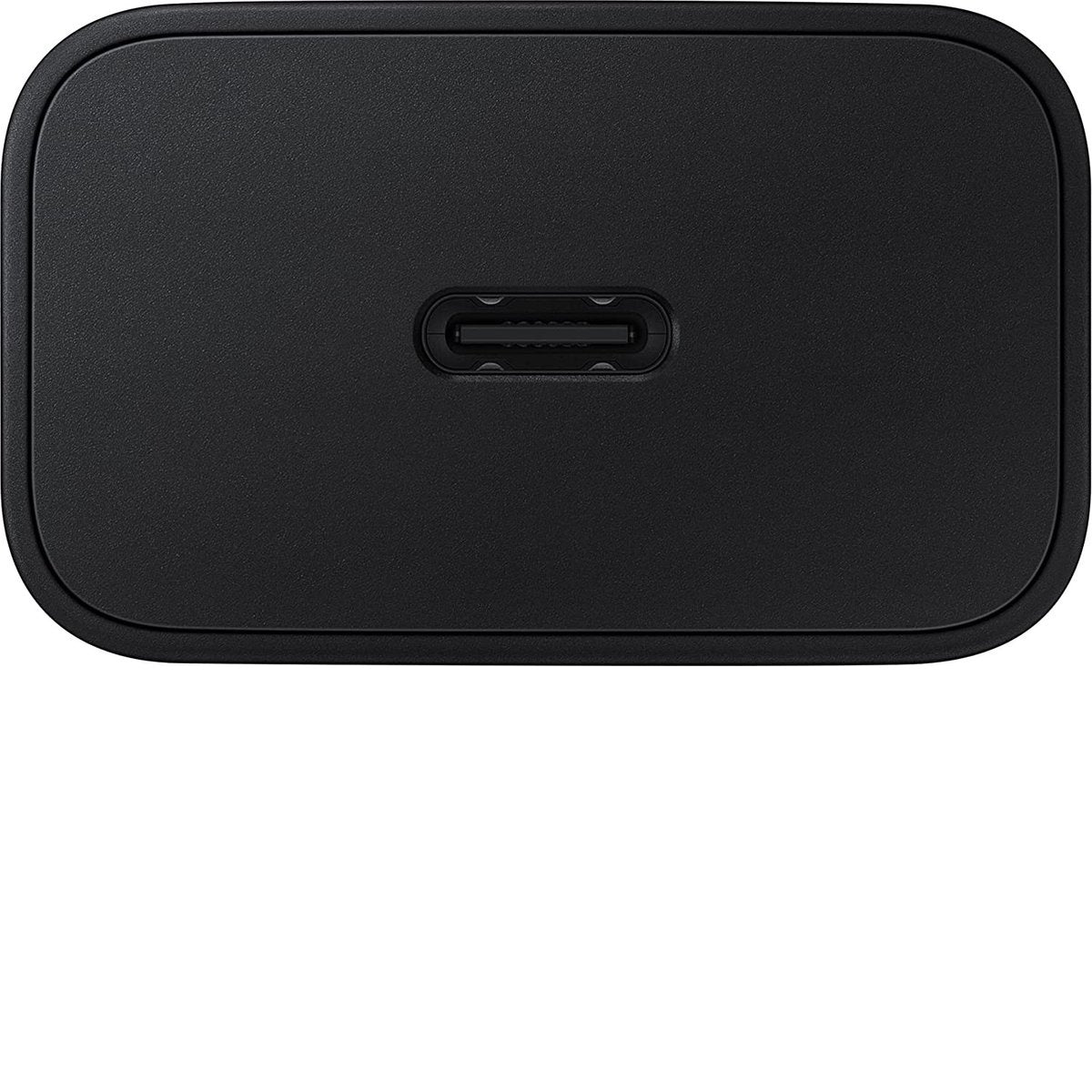 A close-up of a black USB-C charger, showing the port. The charger has rounded corners and a matte finish.
