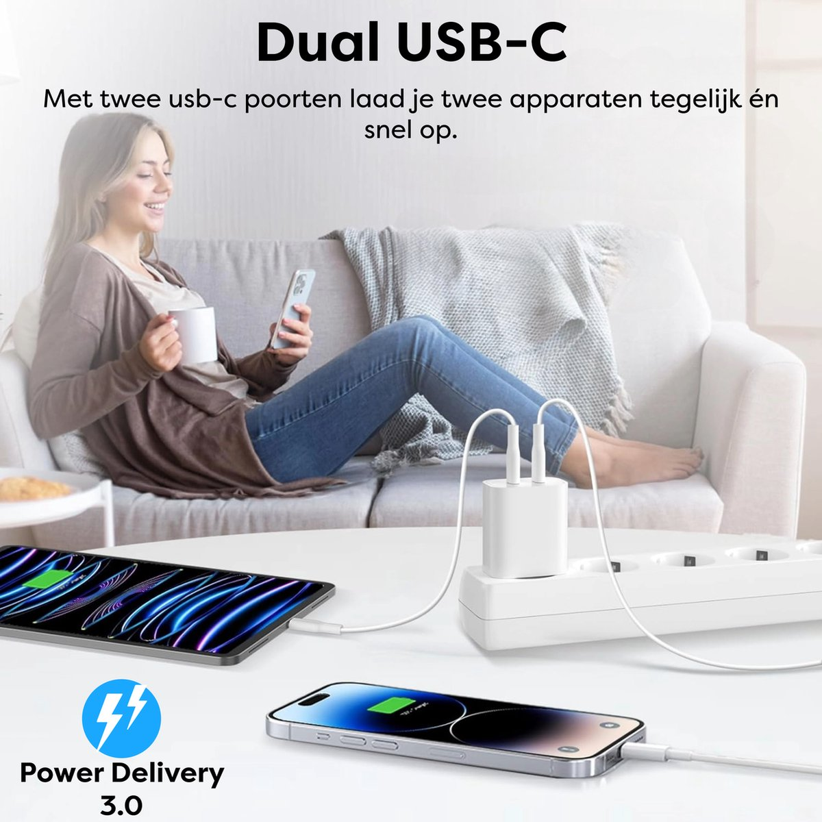 Woman on sofa uses phone and holds mug. USB-C charger with two phones and a tablet charging on a table. Power Delivery 3.0.