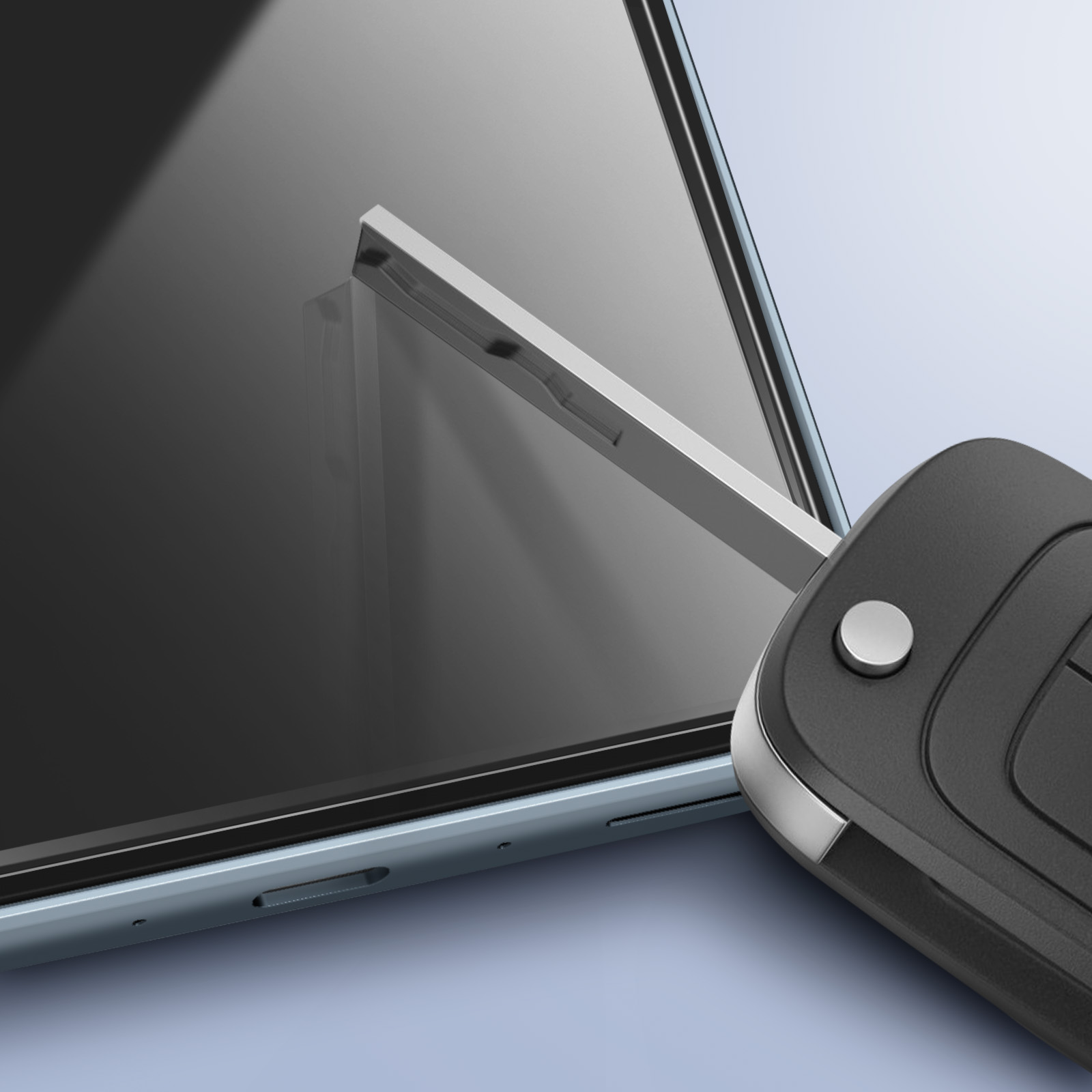 Una chiave dell'auto accanto a uno smartphone. La chiave è nera e argentata. Il telefono è nero.