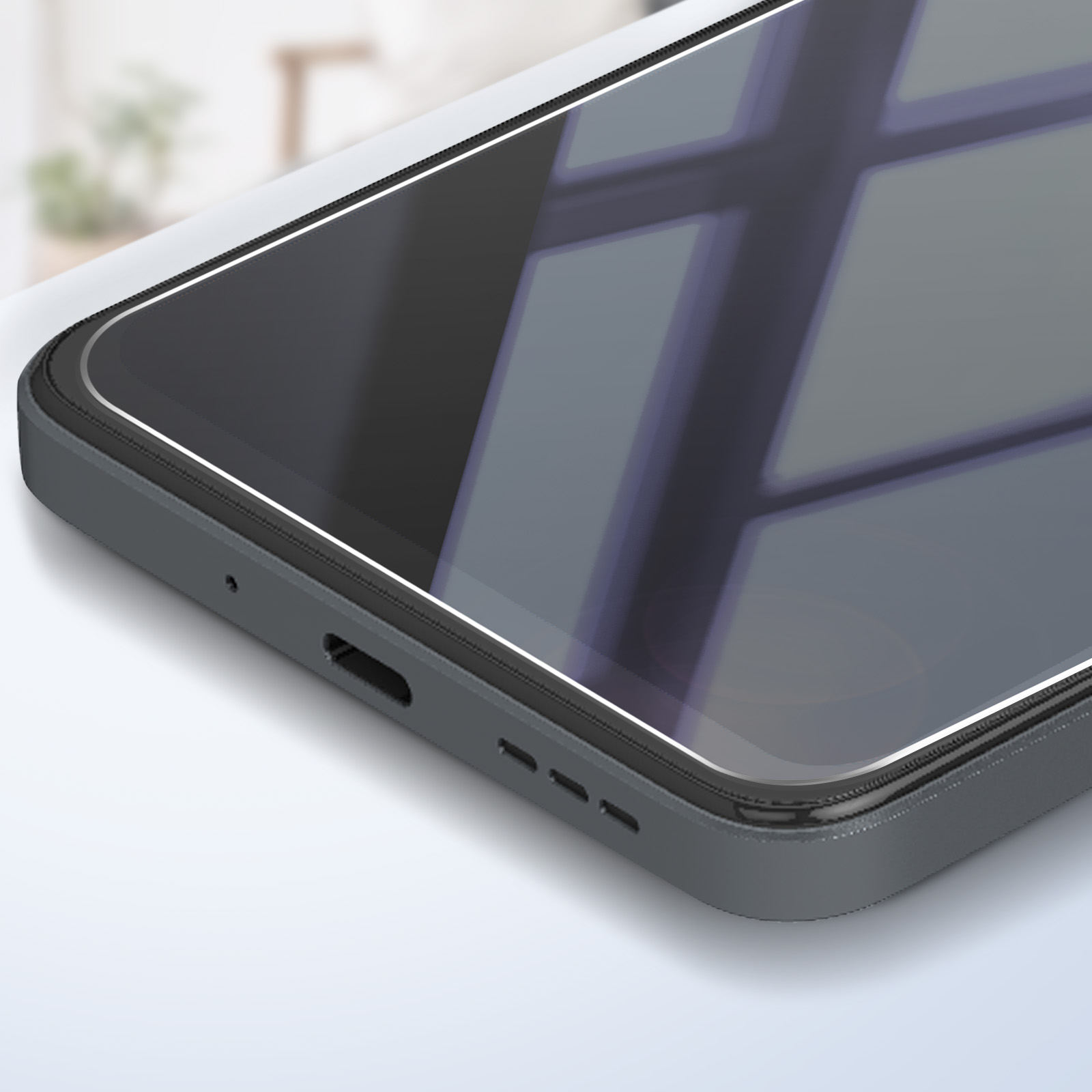 Primo piano di uno smartphone grigio scuro. Lo schermo riflette una finestra, i bordi sono arrotondati e ci sono porte in basso.