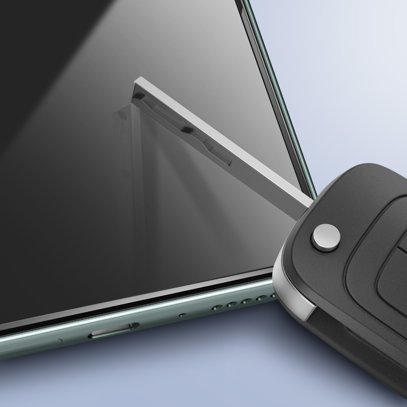 Una chiave per auto nera accanto a uno smartphone. Il telefono è nero con cornice verde. La chiave ha un pulsante argentato.