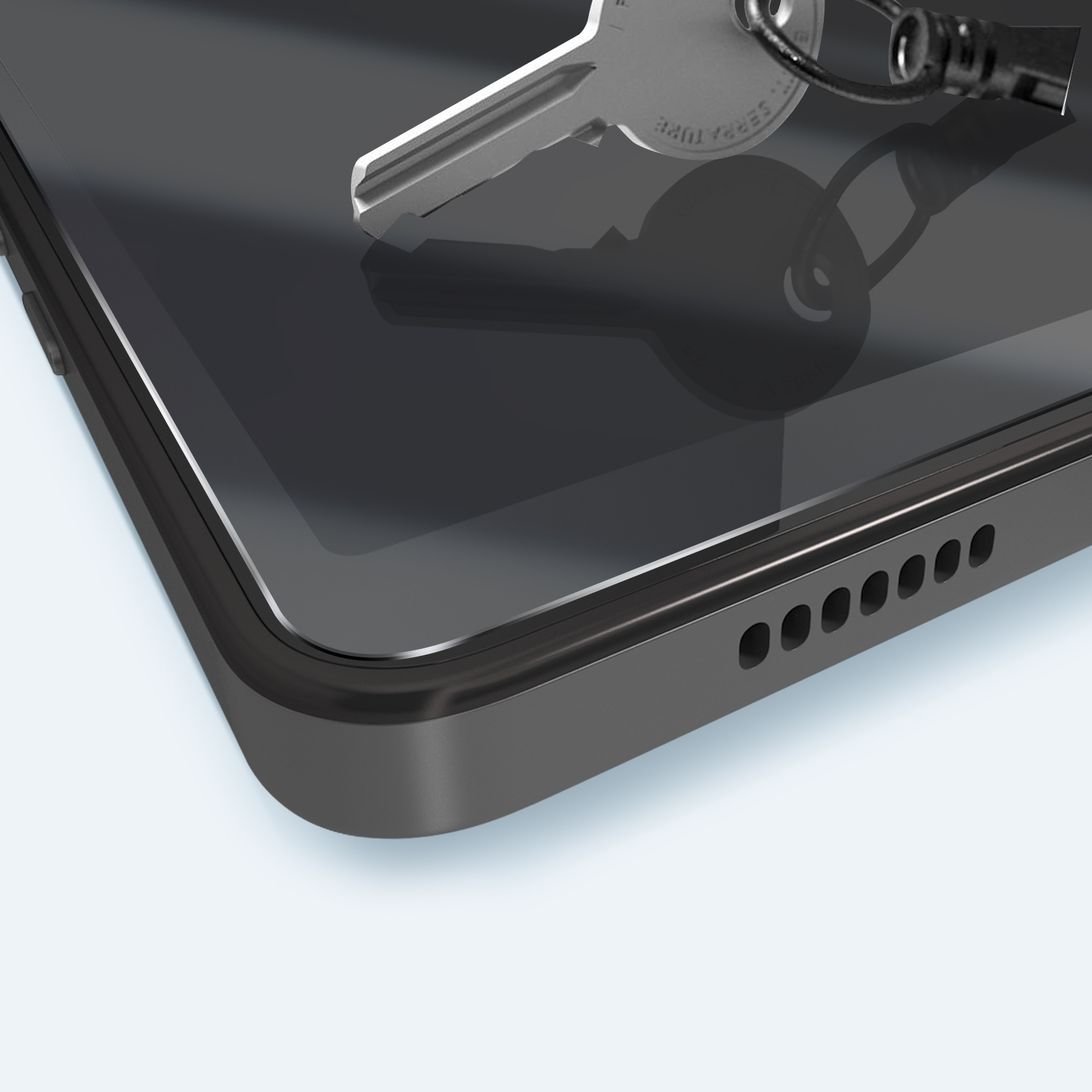 Primo piano di una chiave appoggiata su un dispositivo scuro, forse un tablet, con la sua ombra. Lo sfondo è azzurro chiaro.