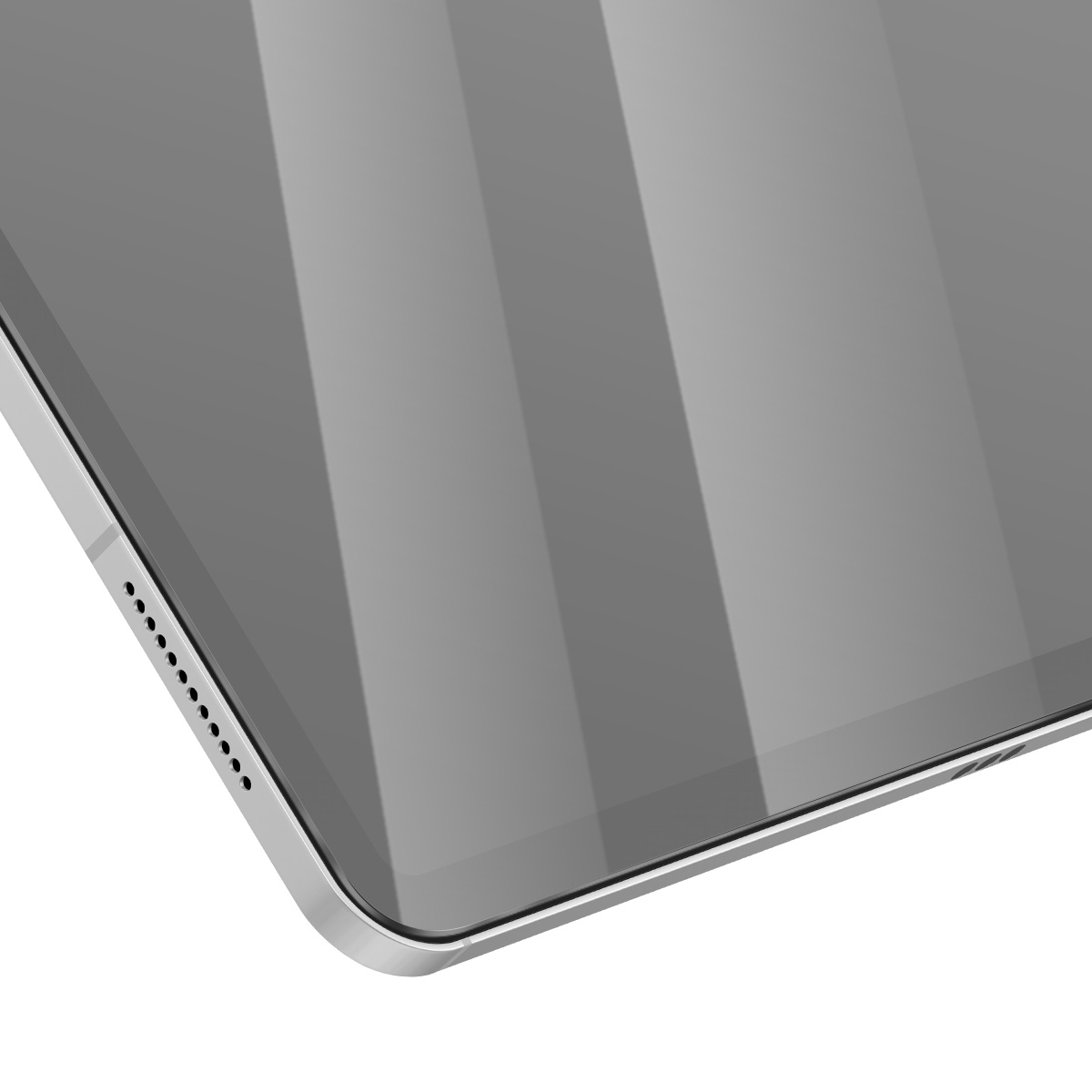 Primo piano di un angolo del tablet. Lo schermo è grigio con riflessi. Cornice argentata con fori per altoparlanti sul lato. Sfondo bianco.