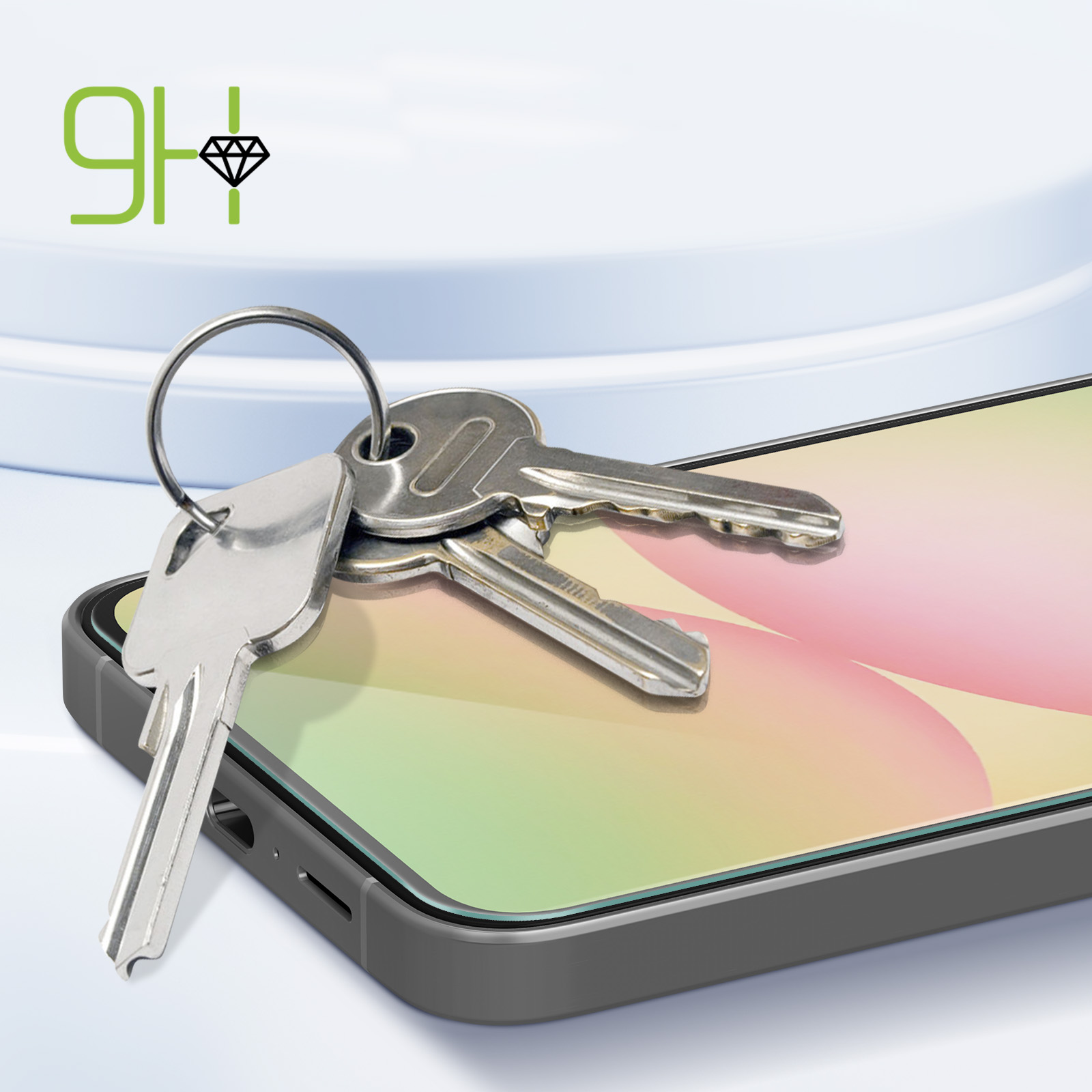 Le chiavi sono appoggiate sullo schermo di un telefono. Lo schermo ha una sfumatura arcobaleno. Il telefono è grigio.