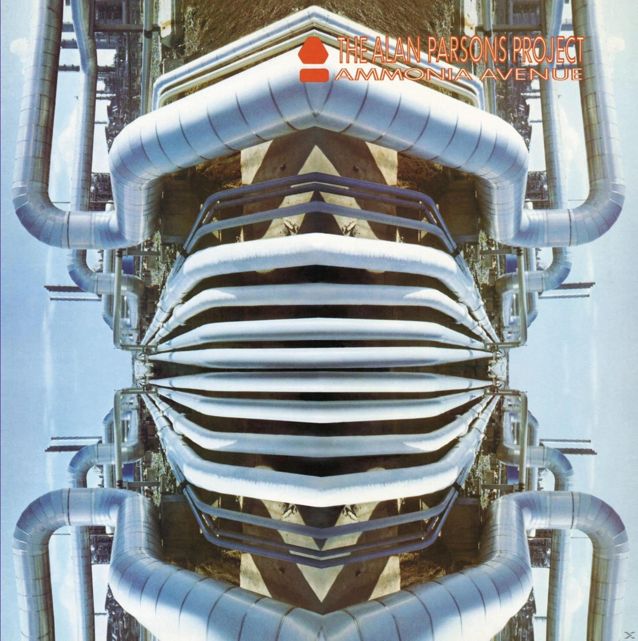 Verspiegelte Industrieanlagen und Strukturen dominieren die Szene, mit blauem Himmel im Hintergrund. Der Albumtitel "Ammonia Avenue" ist sichtbar.