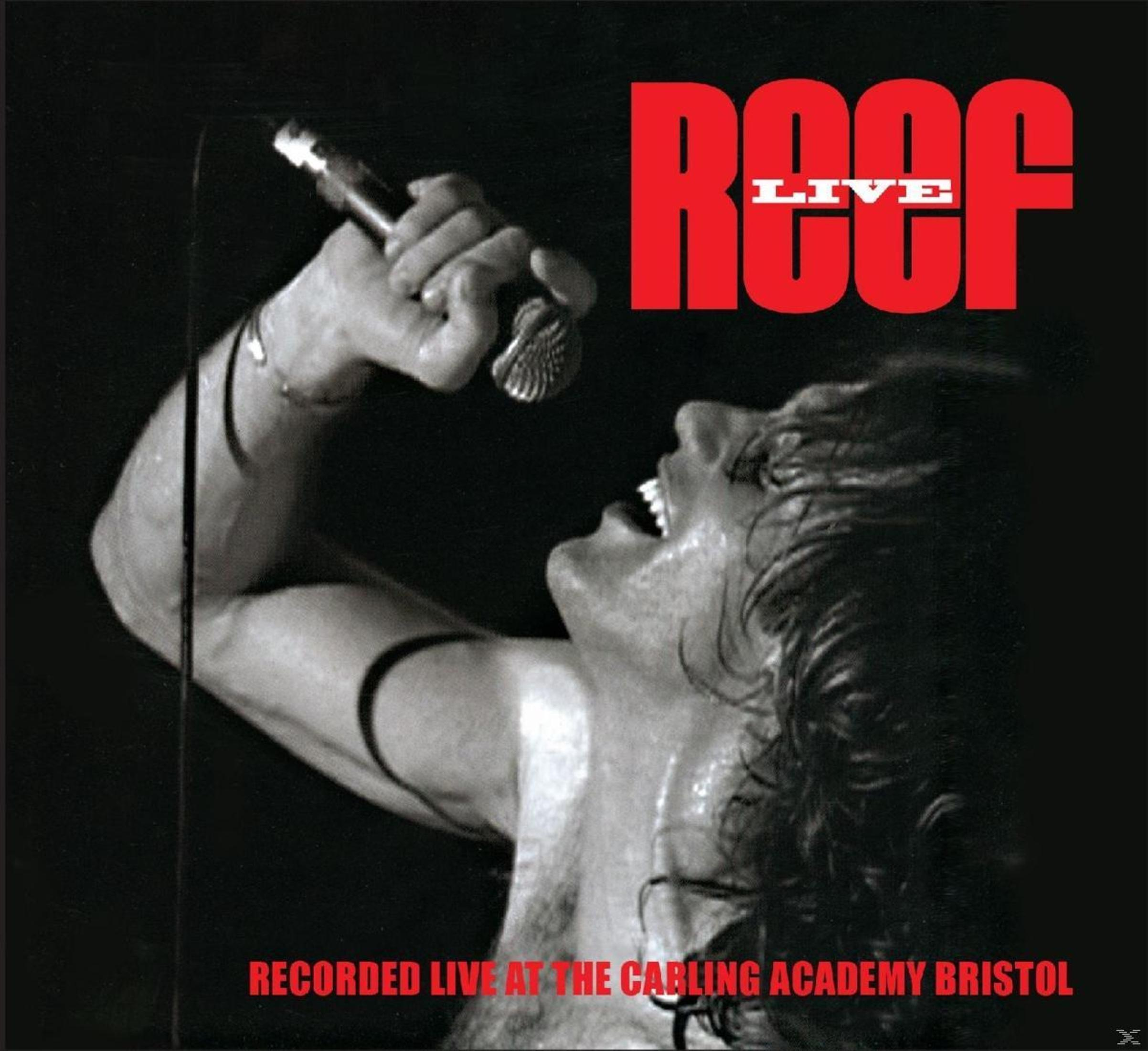 A man sings into a microphone. Red text says 'ROOF LIVE'.  Text at the bottom says 'RECORDED LIVE AT THE CARLING ACADEMY BRISTOL'.
