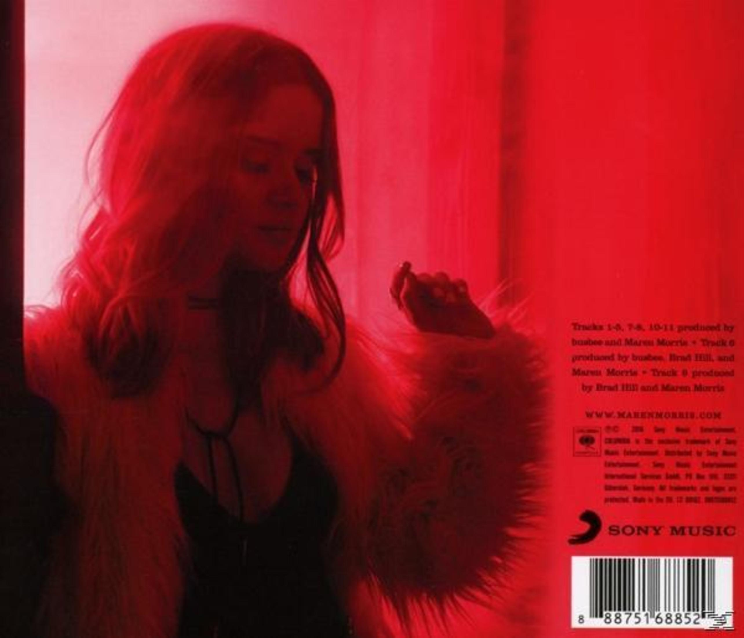 Een vrouw in een bontjas, zwarte top en rood getint haar kijkt naar beneden. Een barcode en tekst over muziekproductie zijn zichtbaar.