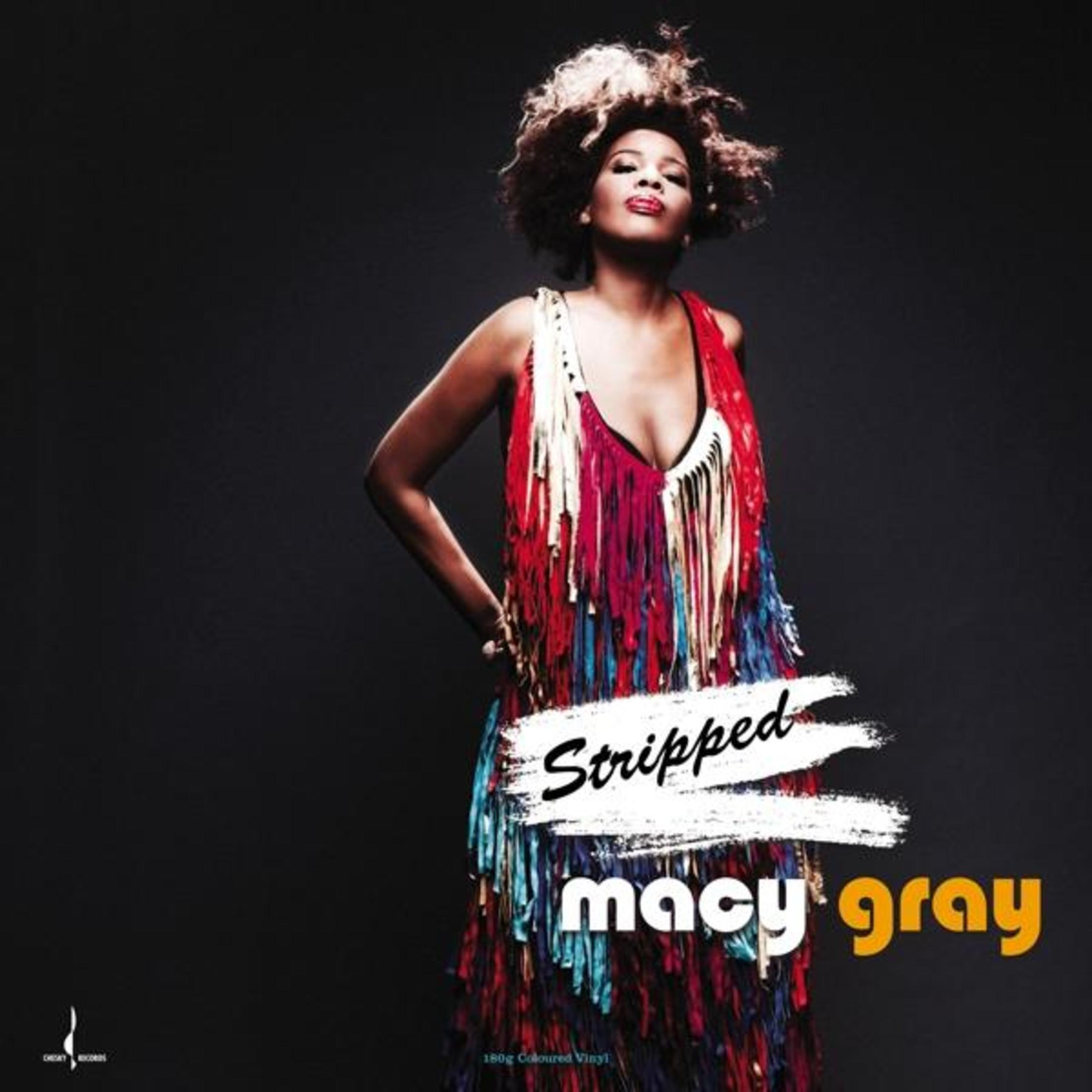 Macy Gray sulla copertina dell'album. Indossa un vestito con frange. Il titolo 'Stripped' è scritto sul davanti. Sfondo nero.
