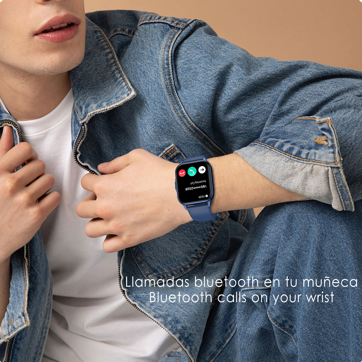 Un uomo con uno smartwatch blu al polso, riceve una chiamata. Indossa una giacca di jeans e una camicia bianca.