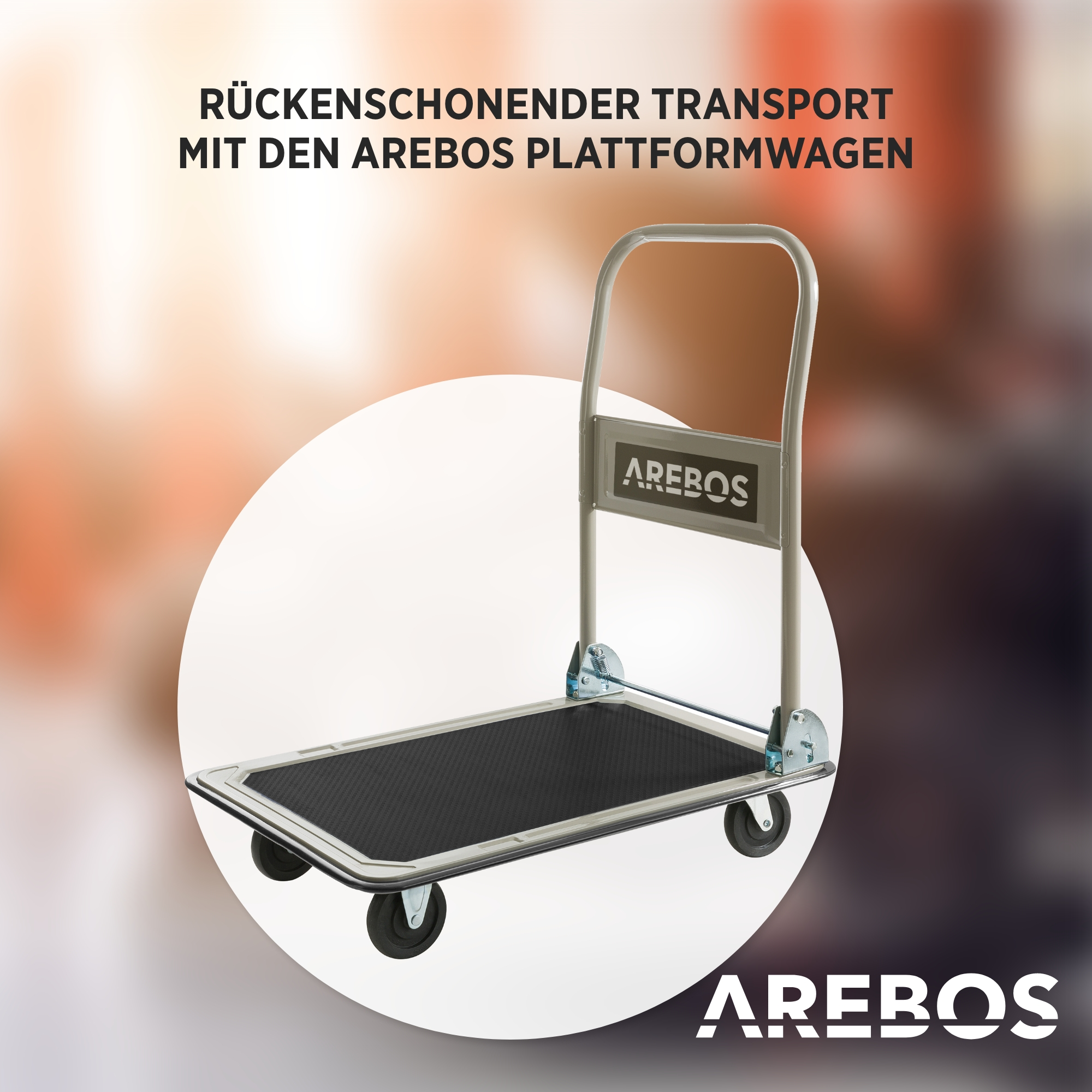 Ein Handwagen mit AREBOS-Logo. Der Wagen ist grau mit schwarzer Plattform und vier schwarzen Rädern. Der Hintergrund ist unscharf.