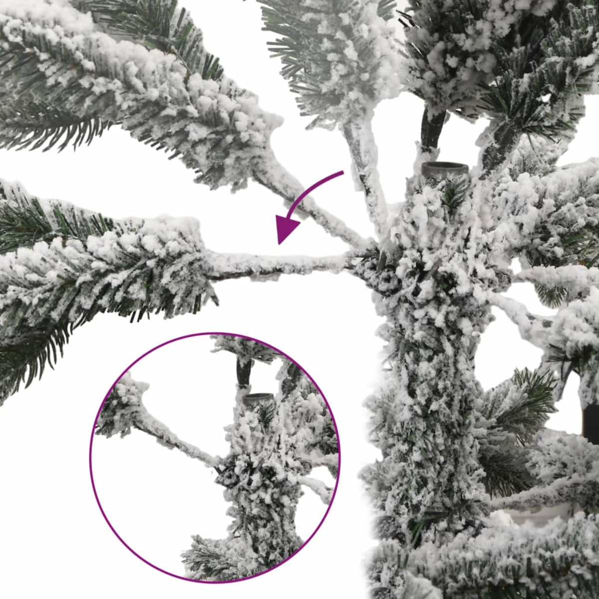 Nahaufnahme eines schneebedeckten künstlichen Weihnachtsbaums. Grüne Nadeln sind mit weißem Schnee bedeckt. Ein lila Kreis hebt einen Ast hervor.