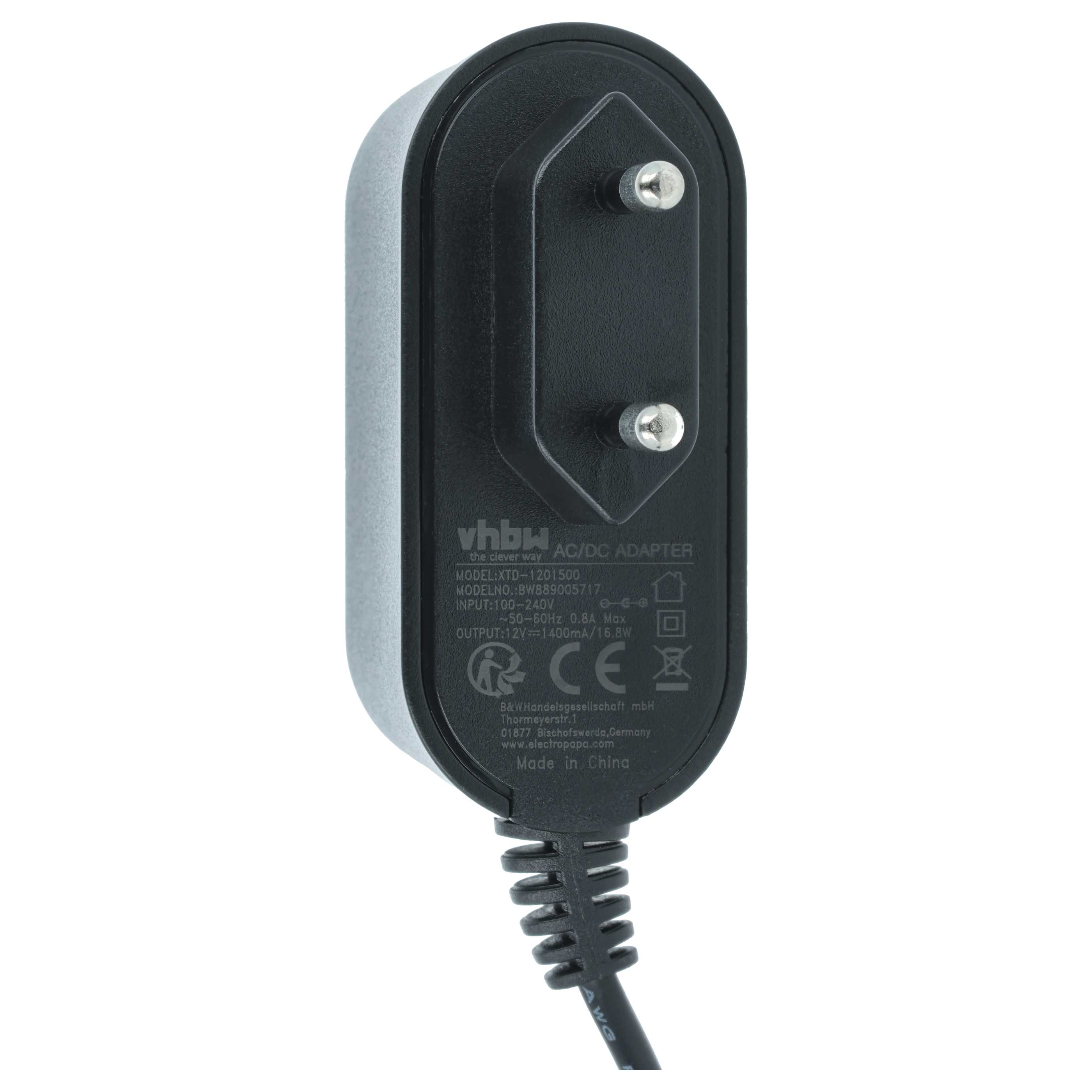 Ein AC/DC-Adapter mit schwarzem Gehäuse, zwei Stiften und einem Etikett mit Spezifikationen. Das Kabel ist schwarz und hat eine AWG-Markierung.