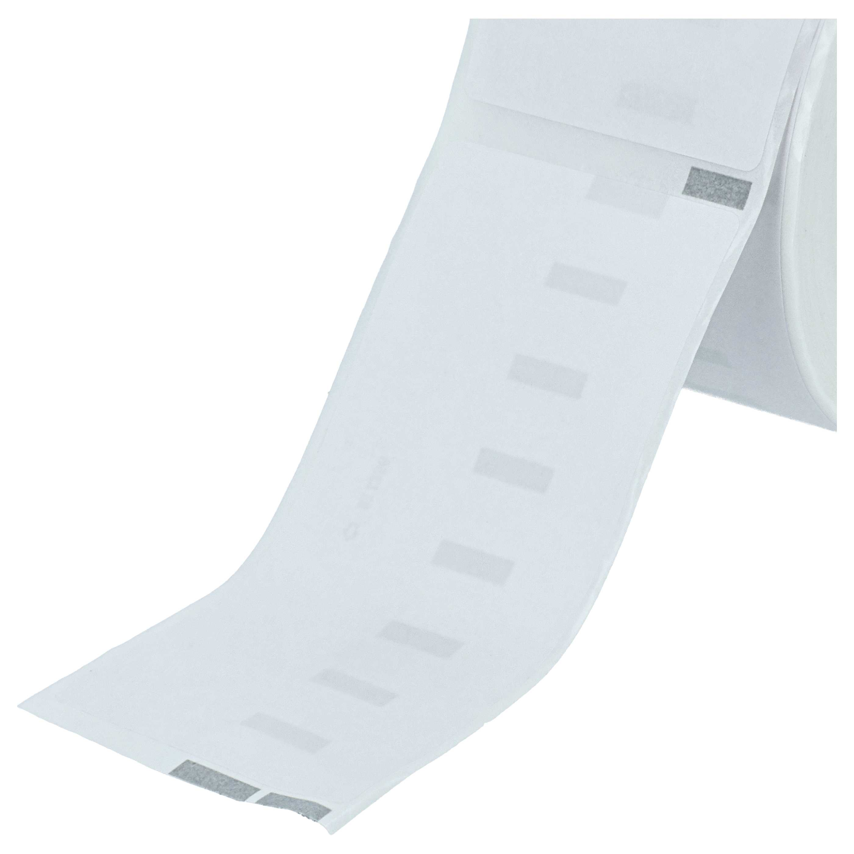 Eine Rolle weißes Papier mit grauen Markierungen. Das Papier ist abgerollt und zeigt rechteckige Formen.