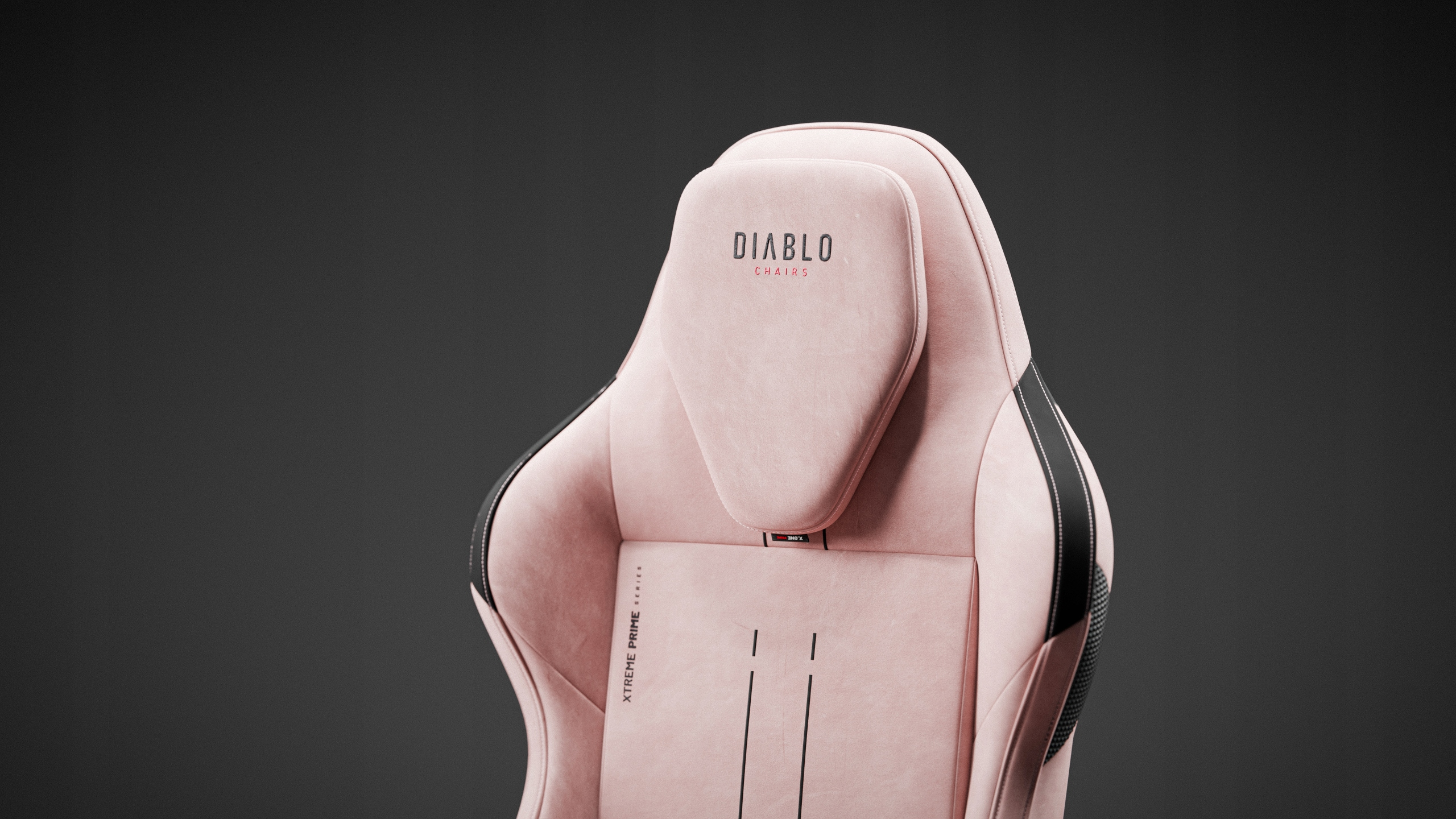 Różowe krzesło gamingowe z czarnymi akcentami na szarym tle. Logo Diablo Chairs znajduje się u góry.