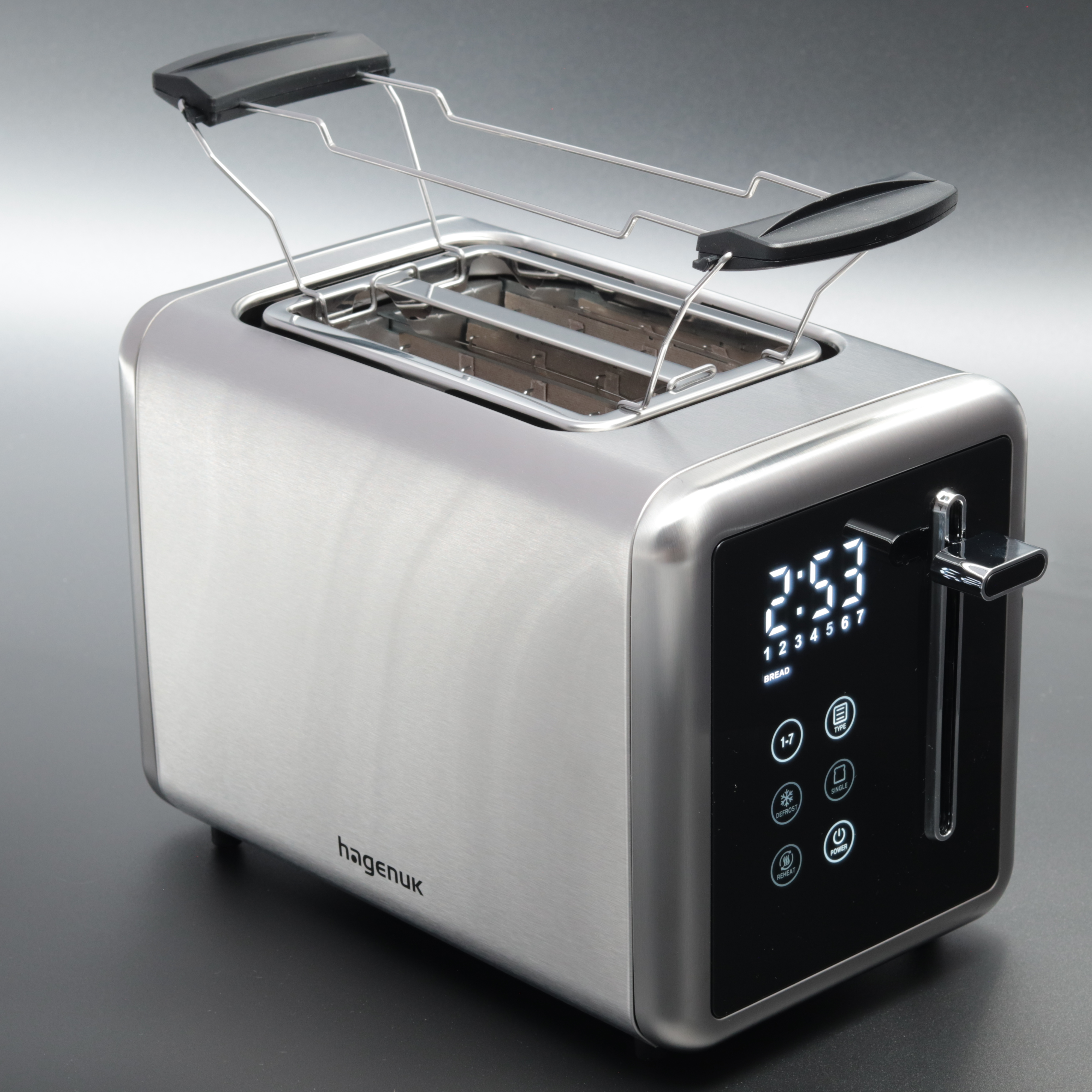Ein silberner Toaster mit digitaler Anzeige 2:53. Oben ist ein Brot-Wärmehalter. Die Marke ist Hagenuk.