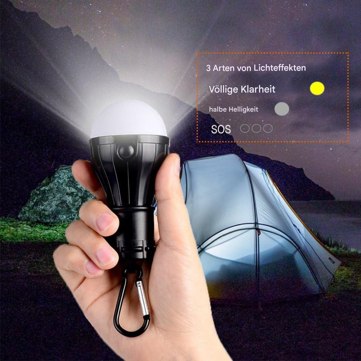 Eine Hand hält eine schwarze Campinglampe. Im Hintergrund ist ein Zelt. Lichtmodi werden angezeigt. Nachthimmel.