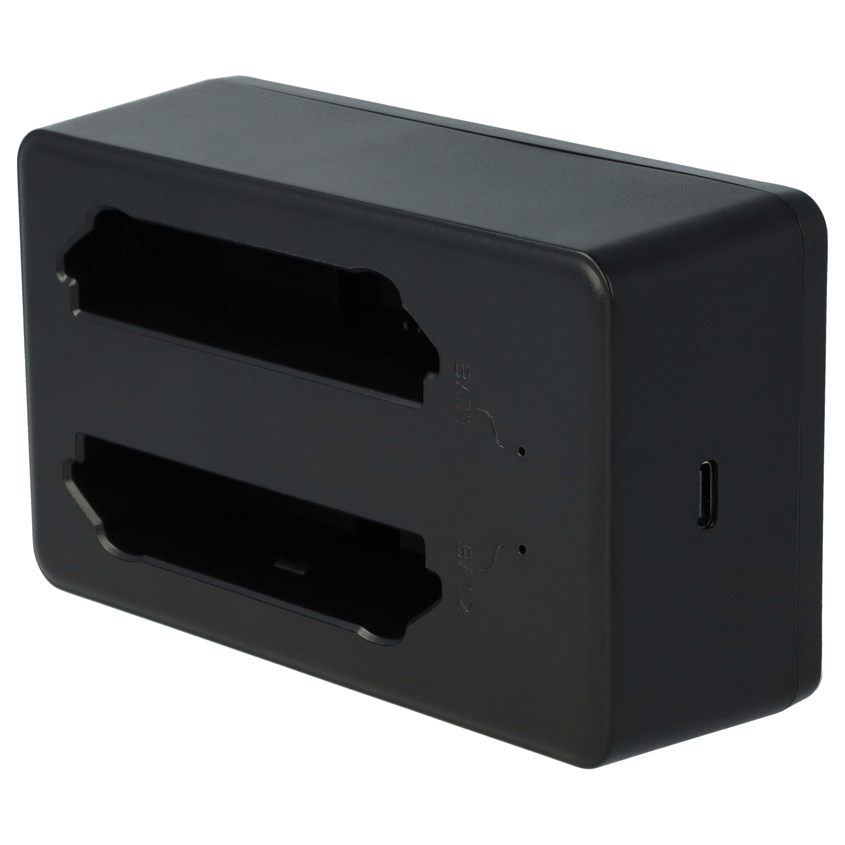Ein schwarzes Batterieladegerät mit zwei Schlitzen. Das Ladegerät hat einen USB-Anschluss und Markierungen.