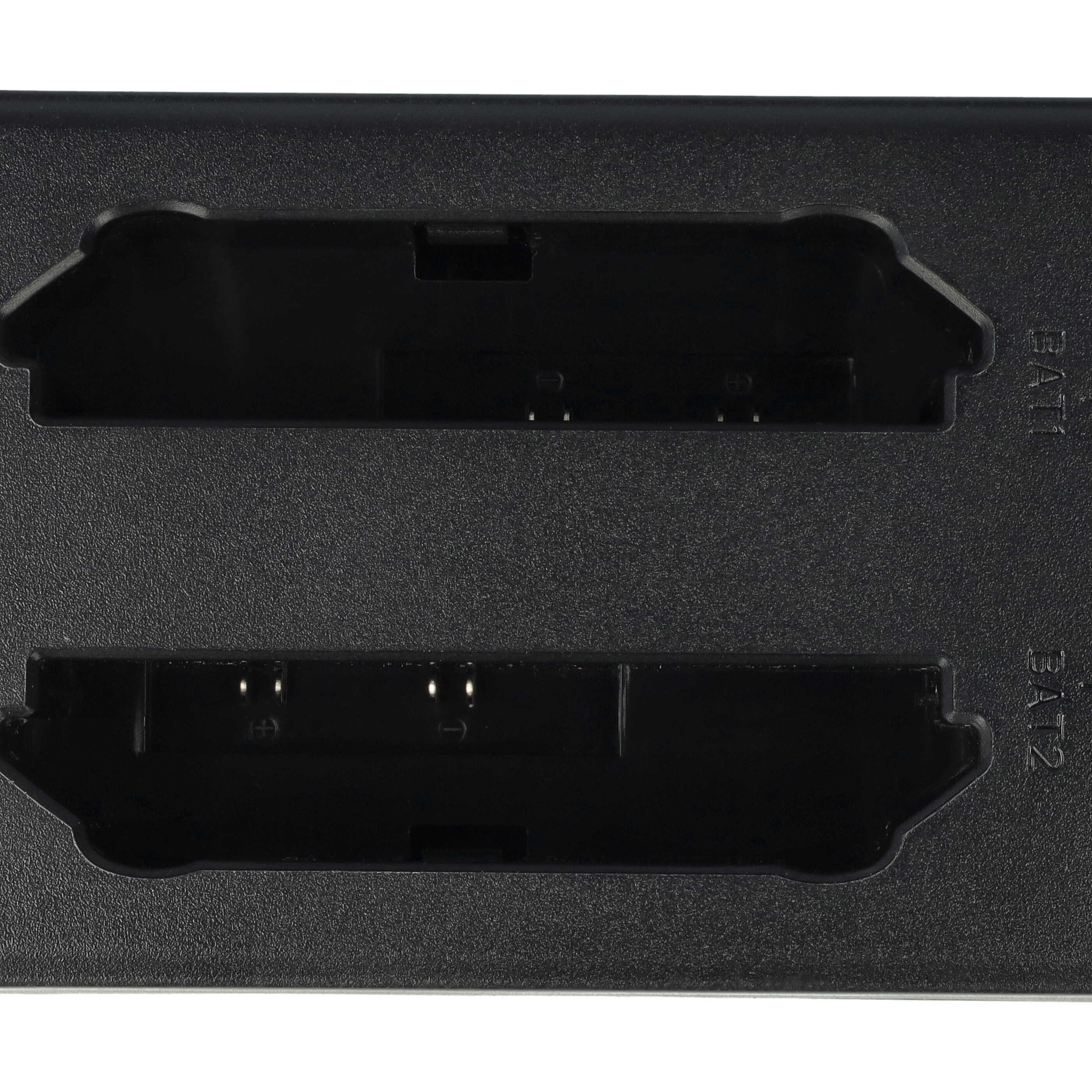 Nahaufnahme eines schwarzen Batterieladegeräts mit zwei Schlitzen mit der Aufschrift BAT1 und BAT2.