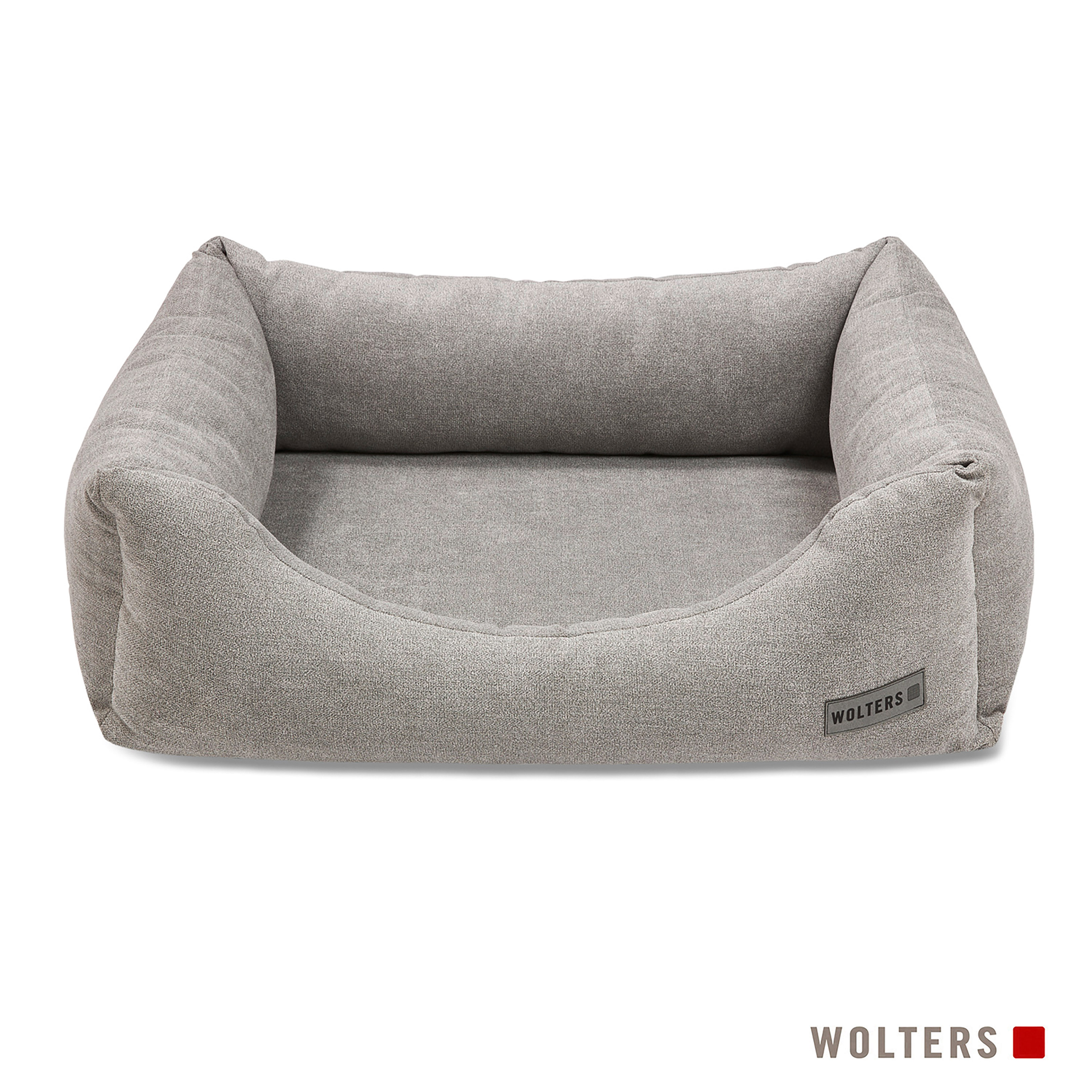 Ein graues Hundebett mit erhöhten Seiten und einer niedrigen Vorderseite. Der Markenname 'WOLTERS' ist sichtbar.