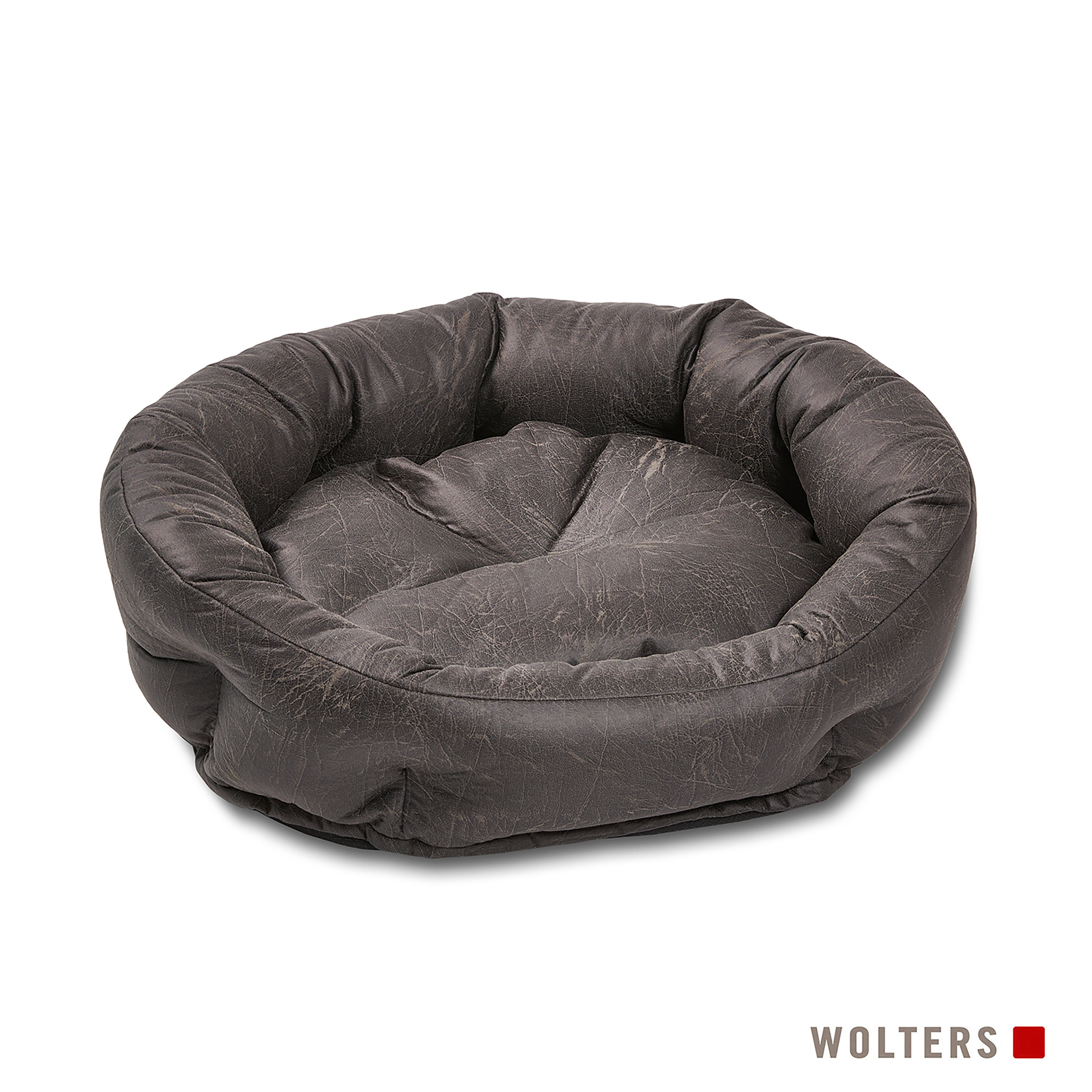 Ein graues, rundes Hundebett mit Kissen. Das Bett besteht aus einem strukturierten Material. Der Hintergrund ist weiß.