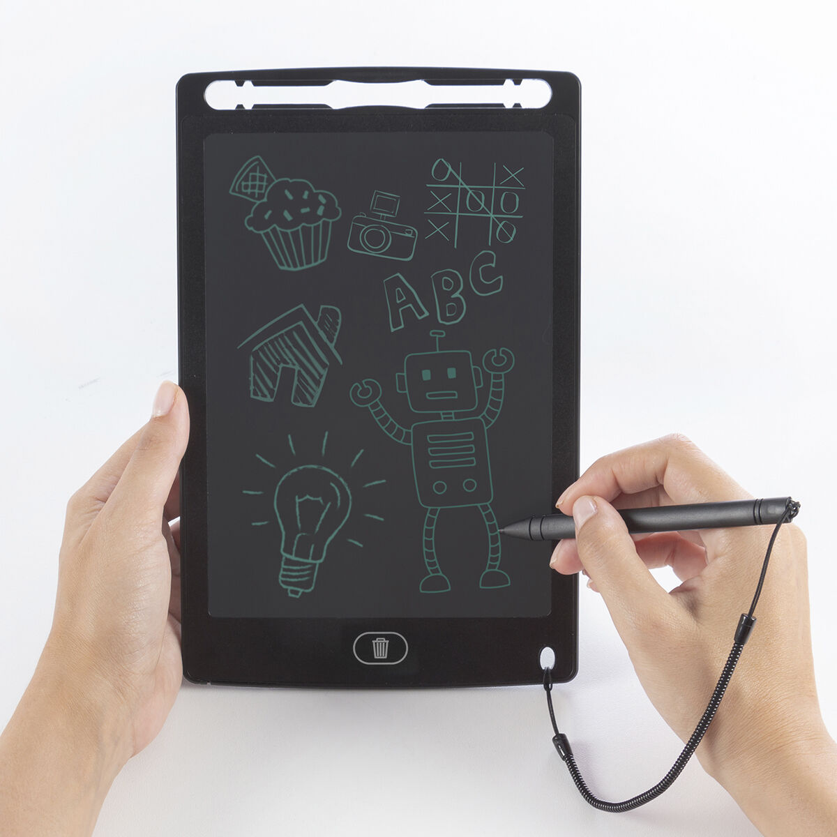 Una persona tiene in mano una tavoletta da disegno nera con disegni verdi di cupcake, fotocamera, tic-tac-toe, ABC, casa, robot e lampadina.
