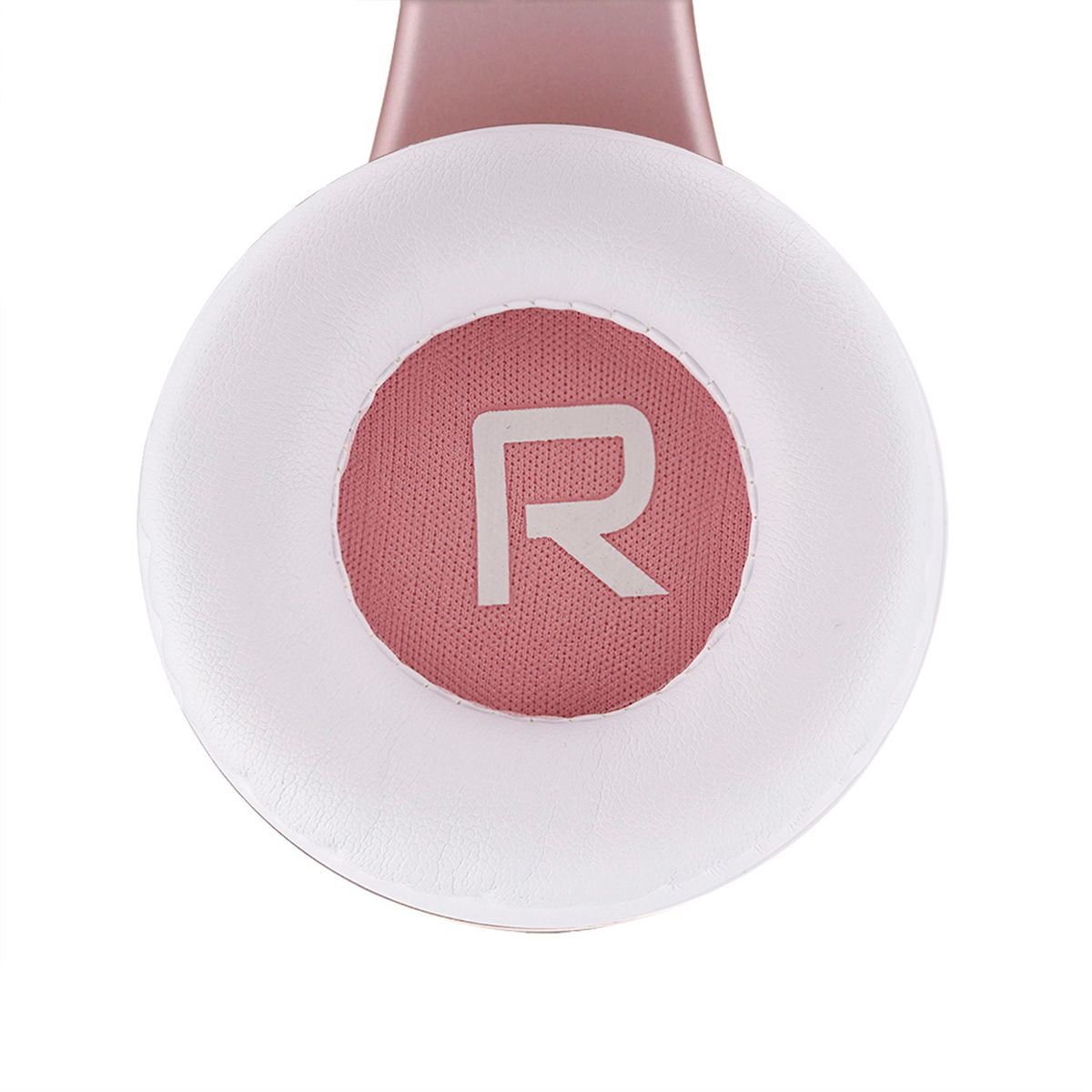 Dettaglio cuffie oro rosa. Cuscino bianco circonda un cerchio di tessuto rosa con una 'R' bianca. Parte superiore della fascia visibile.