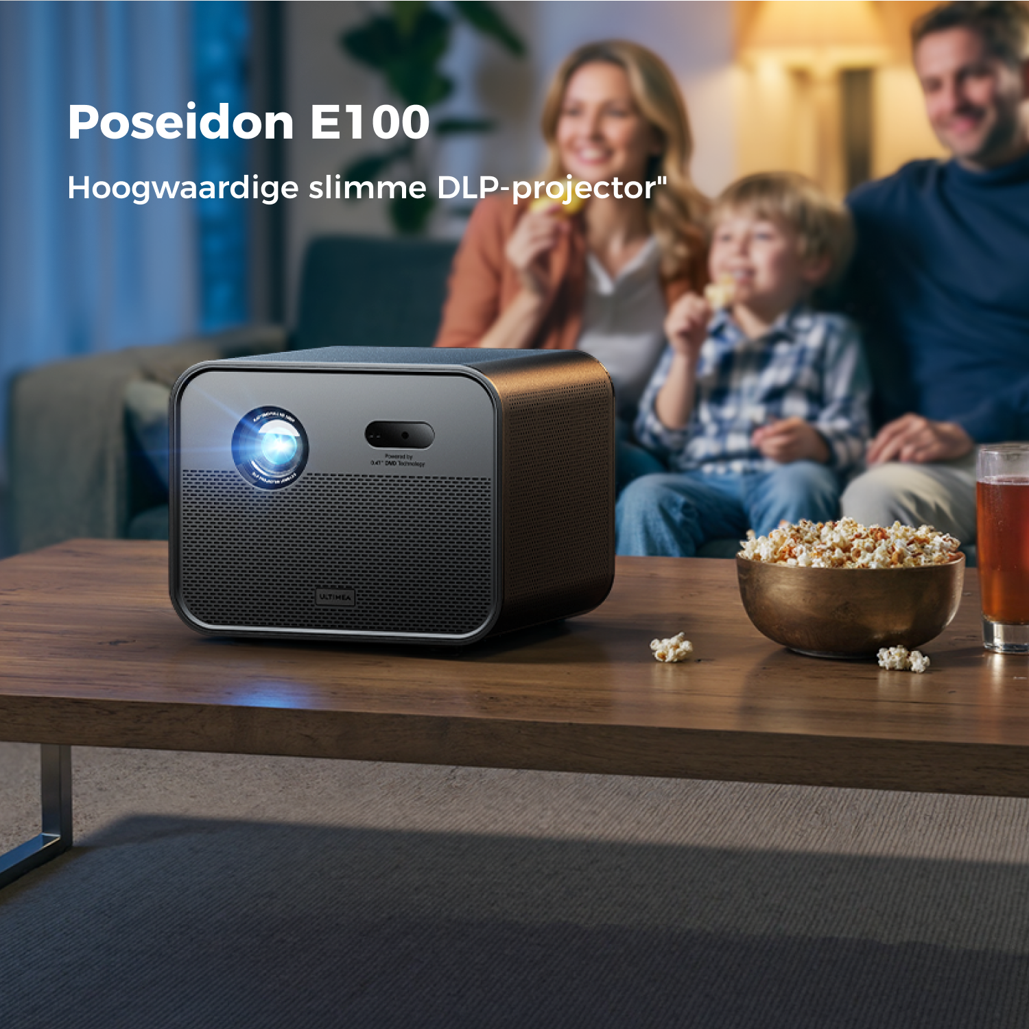 A family watches a movie. A projector sits on a table with popcorn. A glass of beer is on the right.